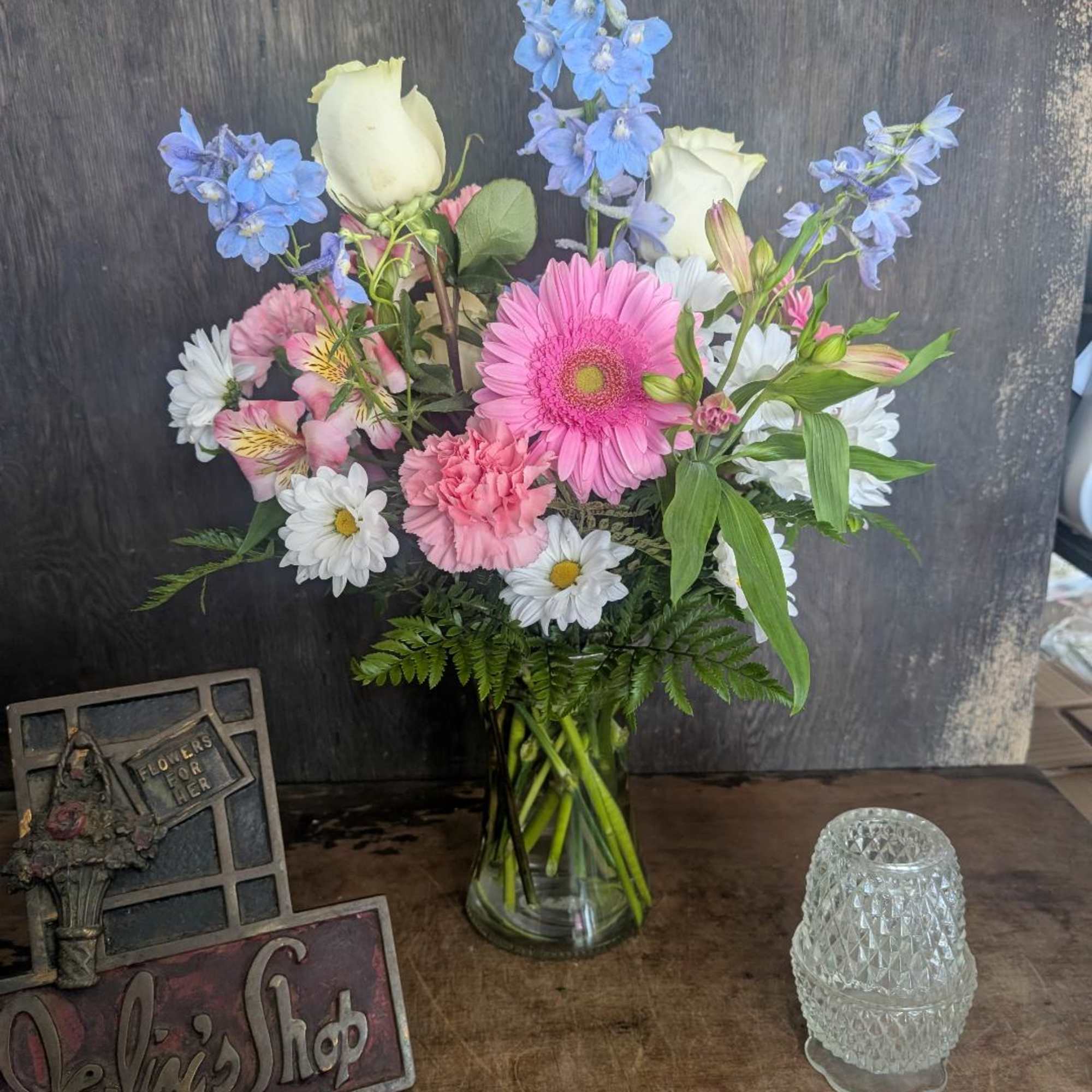 Mixed bouquet in a clear glass vase with pink, white, and blue flowers, photo 2 of 2