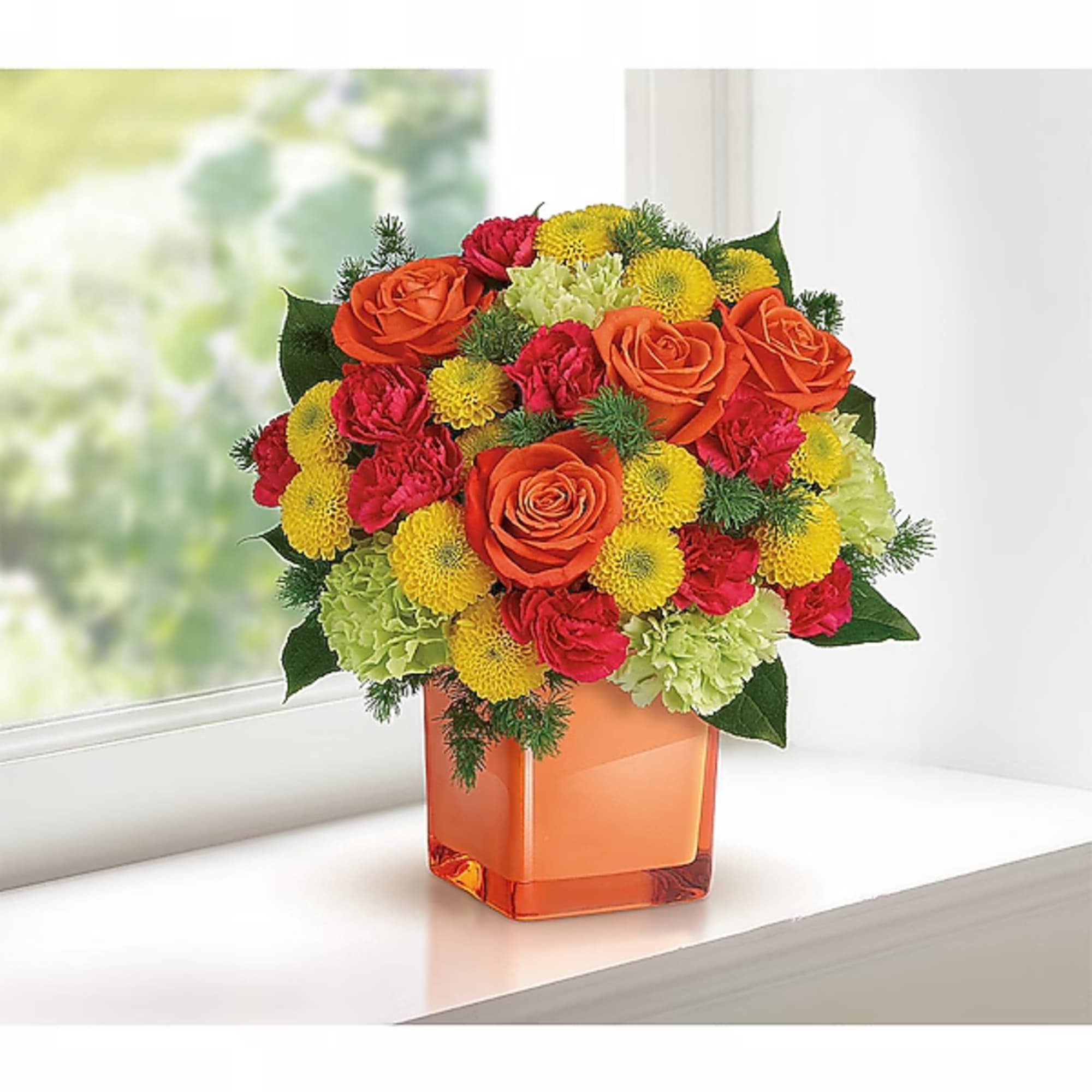 Bouquet of orange roses, red carnations, and yellow mums in an orange vase