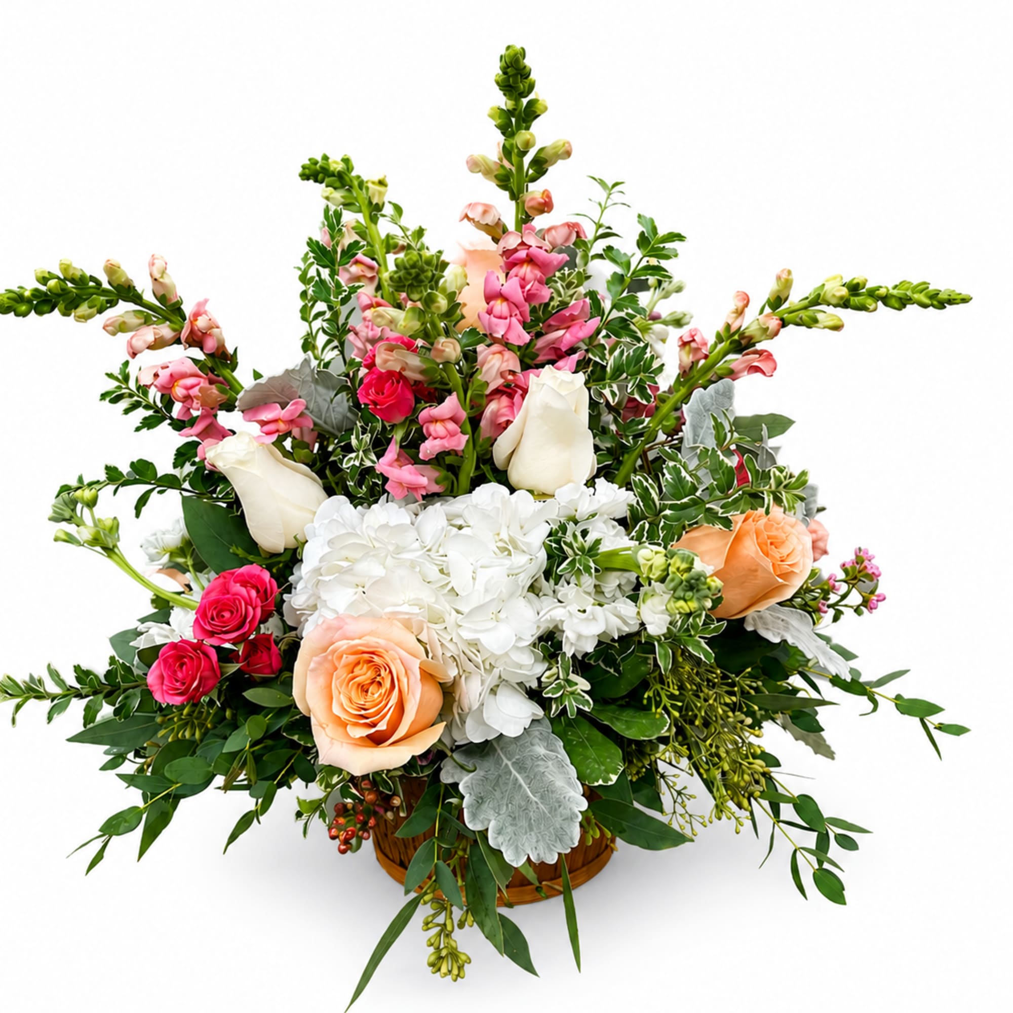 Mixed bouquet with roses, hydrangea, and pink snapdragons in a basket
