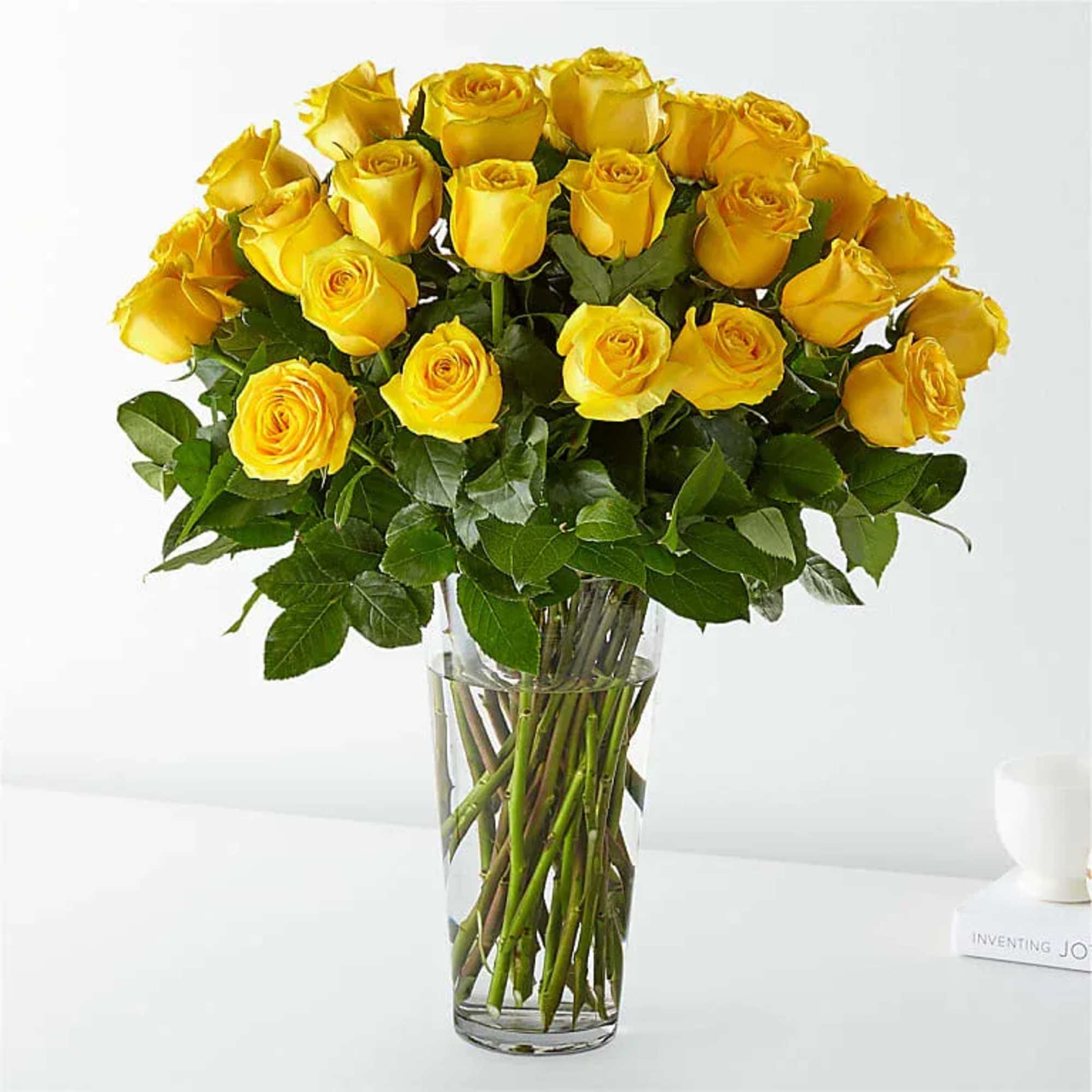 Bouquet of yellow roses in a clear glass vase