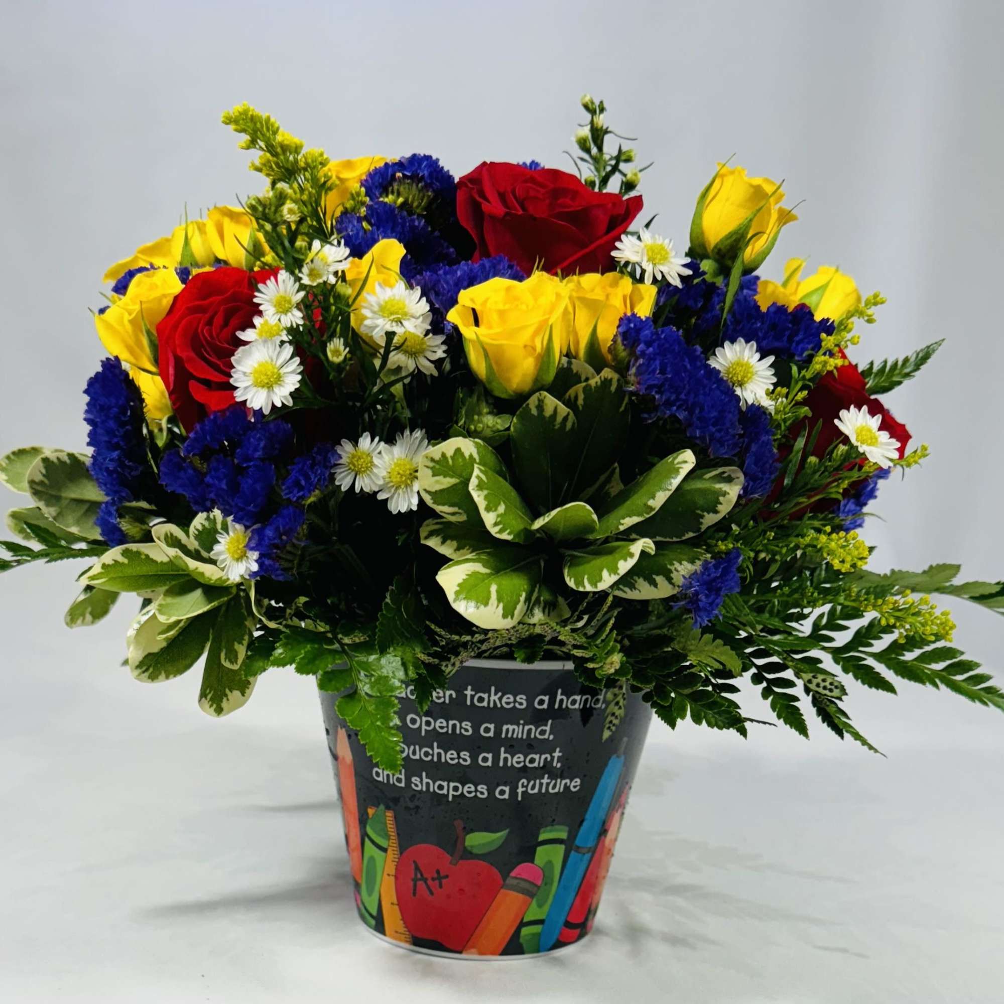 Bright primary colors-clustered red and yellow roses with pops of bright blue