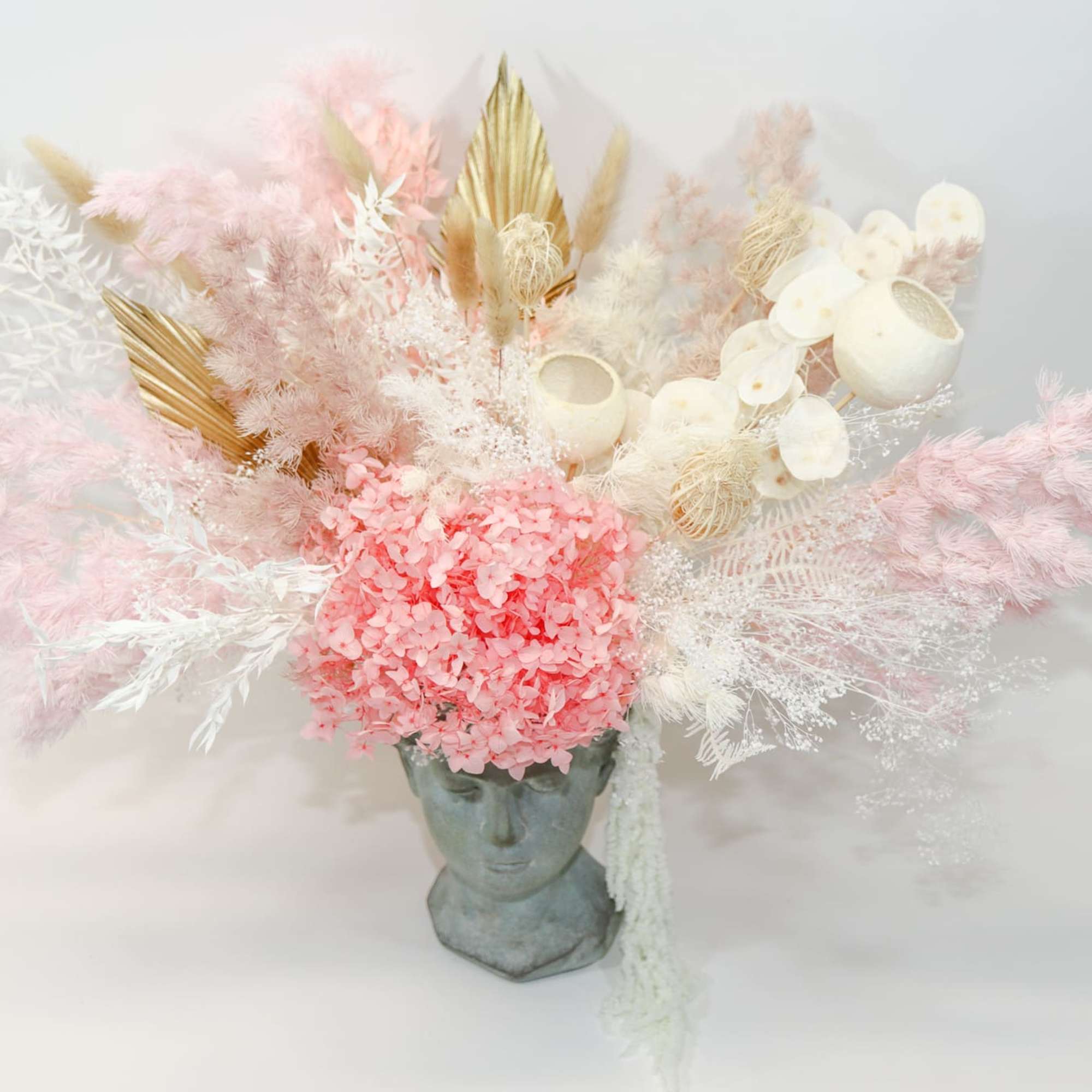 Pink and white dried floral arrangement in a sculpted face vase, photo 3 of 4