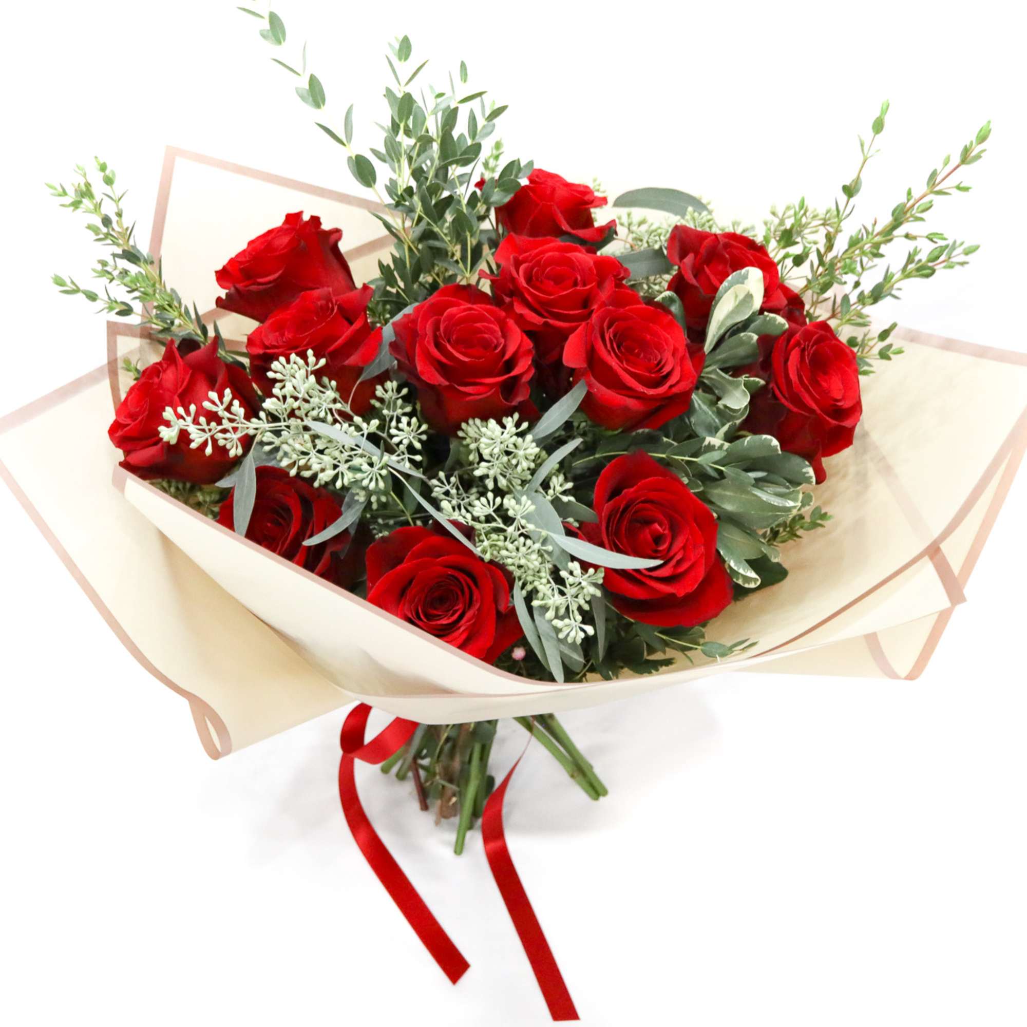 Bouquet of red roses wrapped in cream paper with a red ribbon