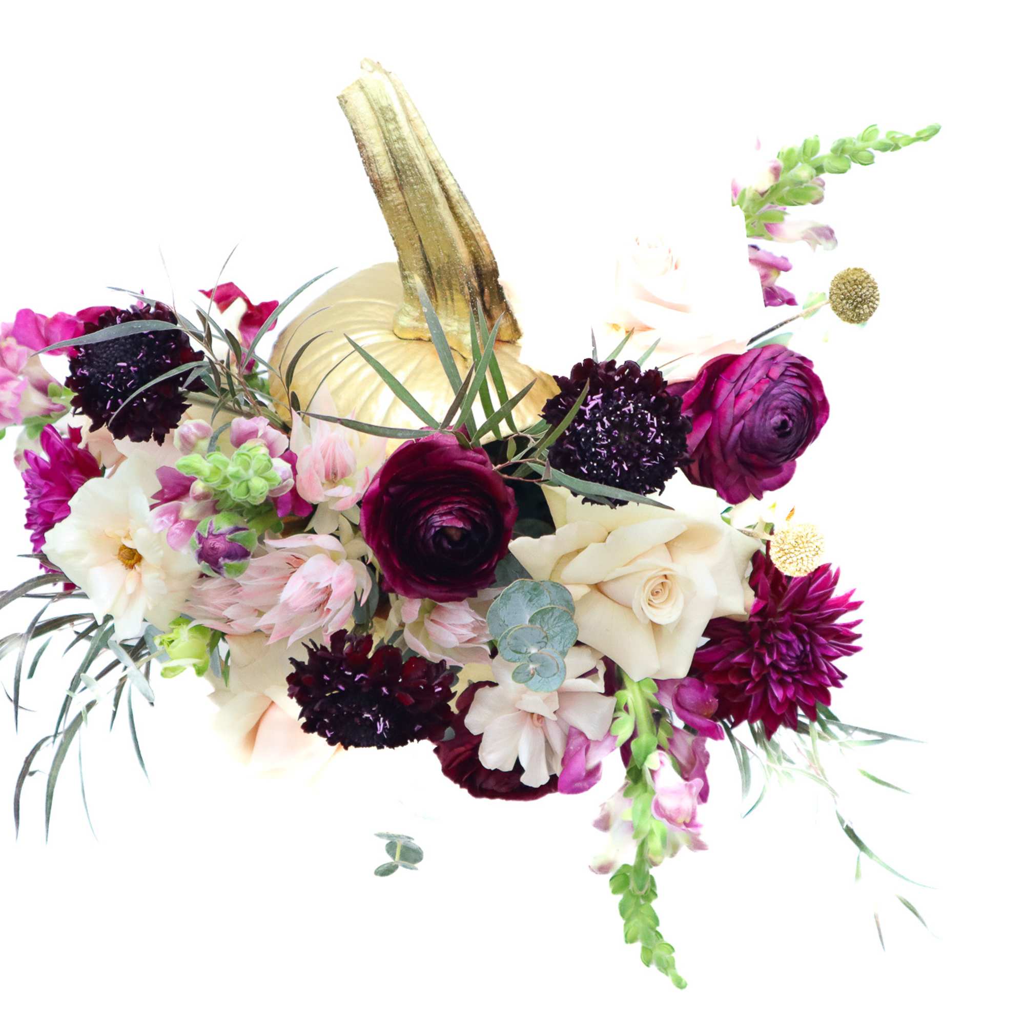 Bouquet with cream, magenta, and purple flowers around a gold pumpkin