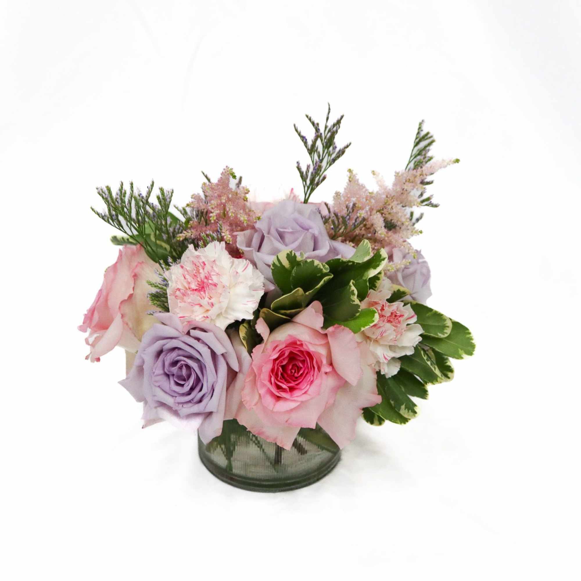 Pink and lavender rose bouquet in a glass vase