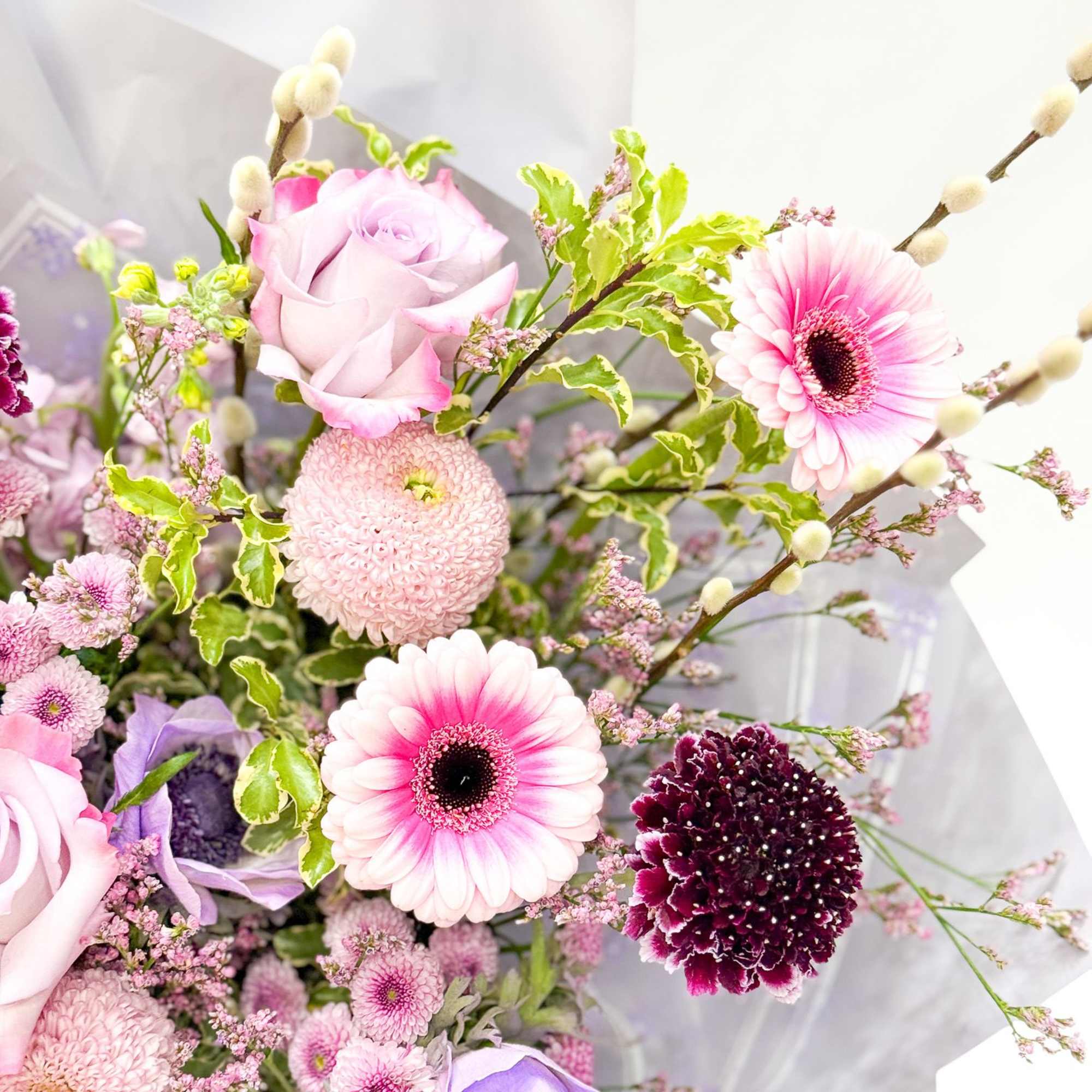 Pink and lavender bouquet with roses, gerbera daisies, and chrysanthemums