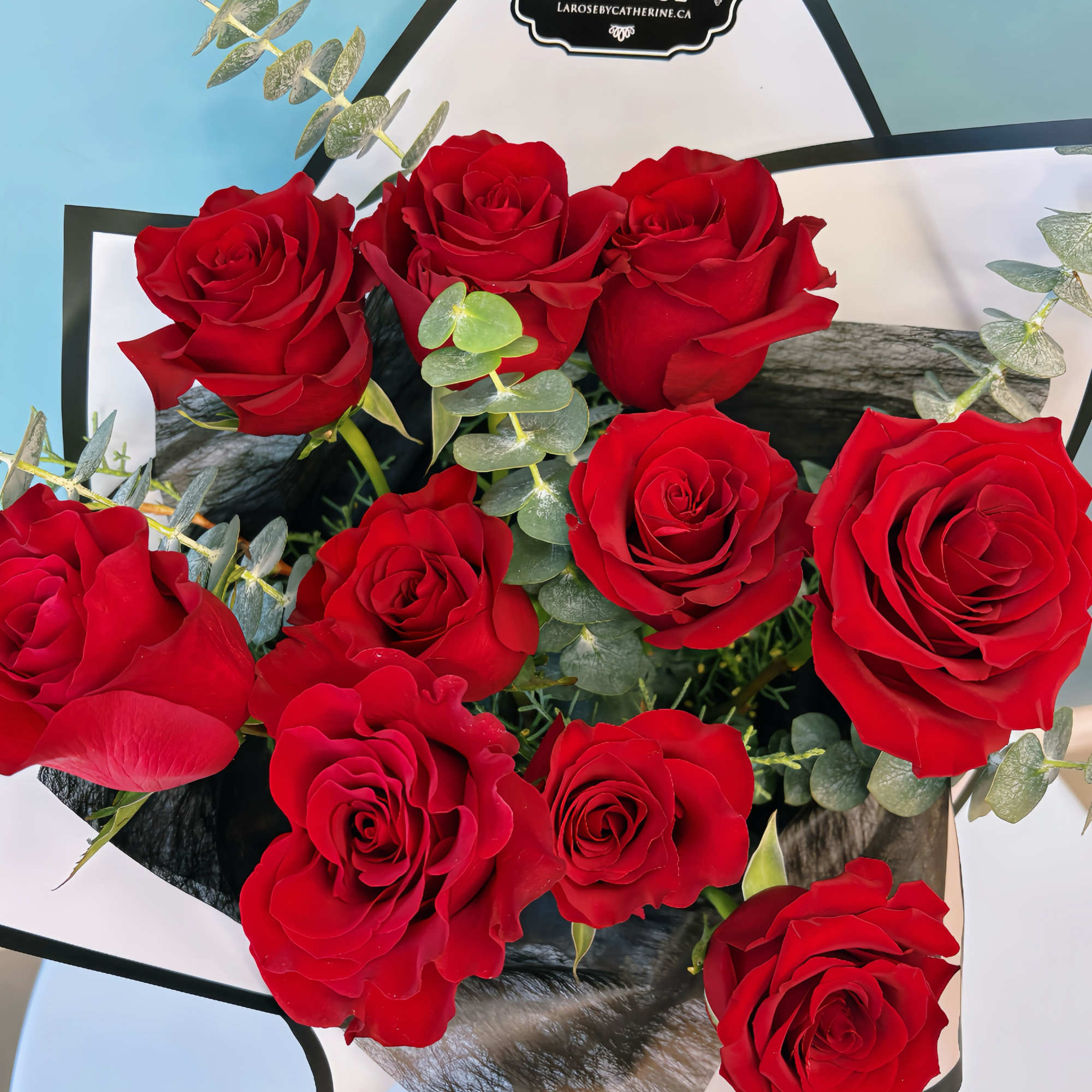 Bouquet of red roses wrapped in black and white paper