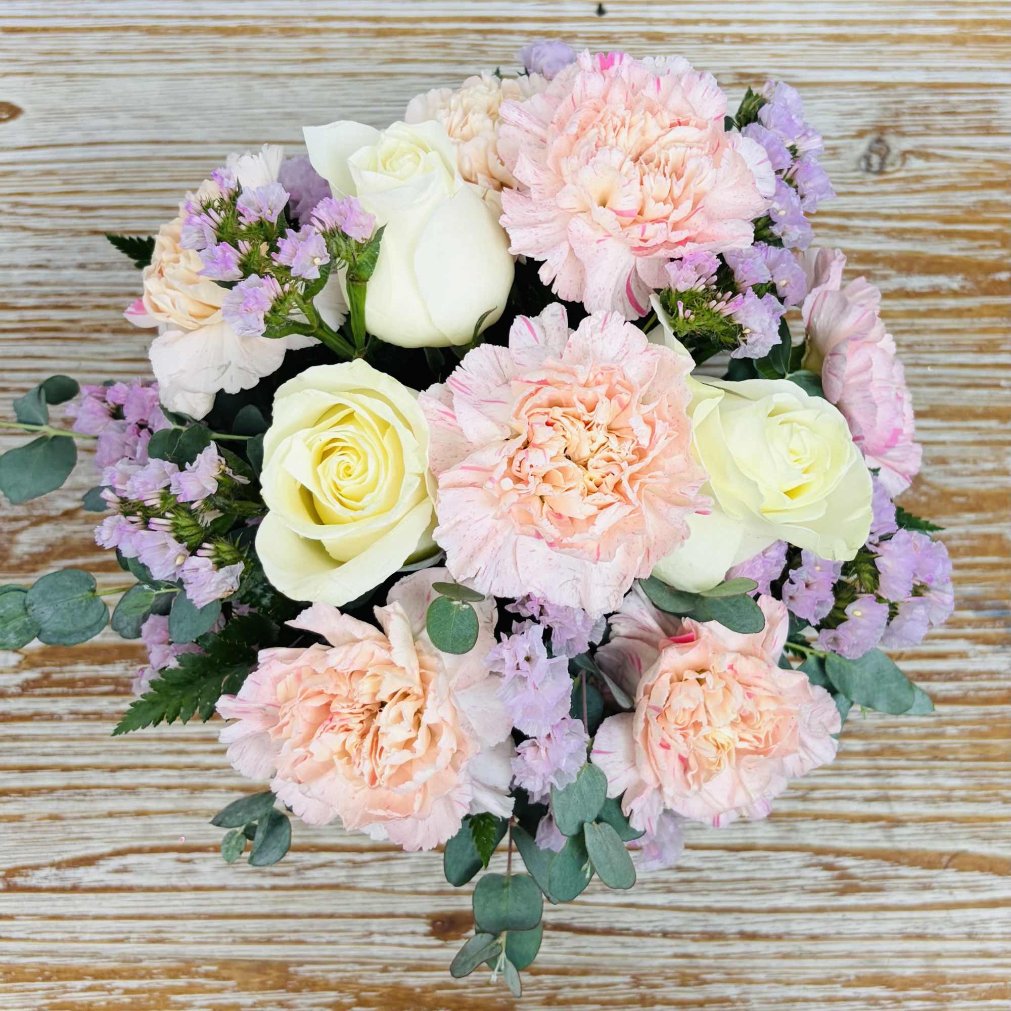 Shades of pink and white blooms arranged in leaf wrapped glass cube, photo 2 of 2