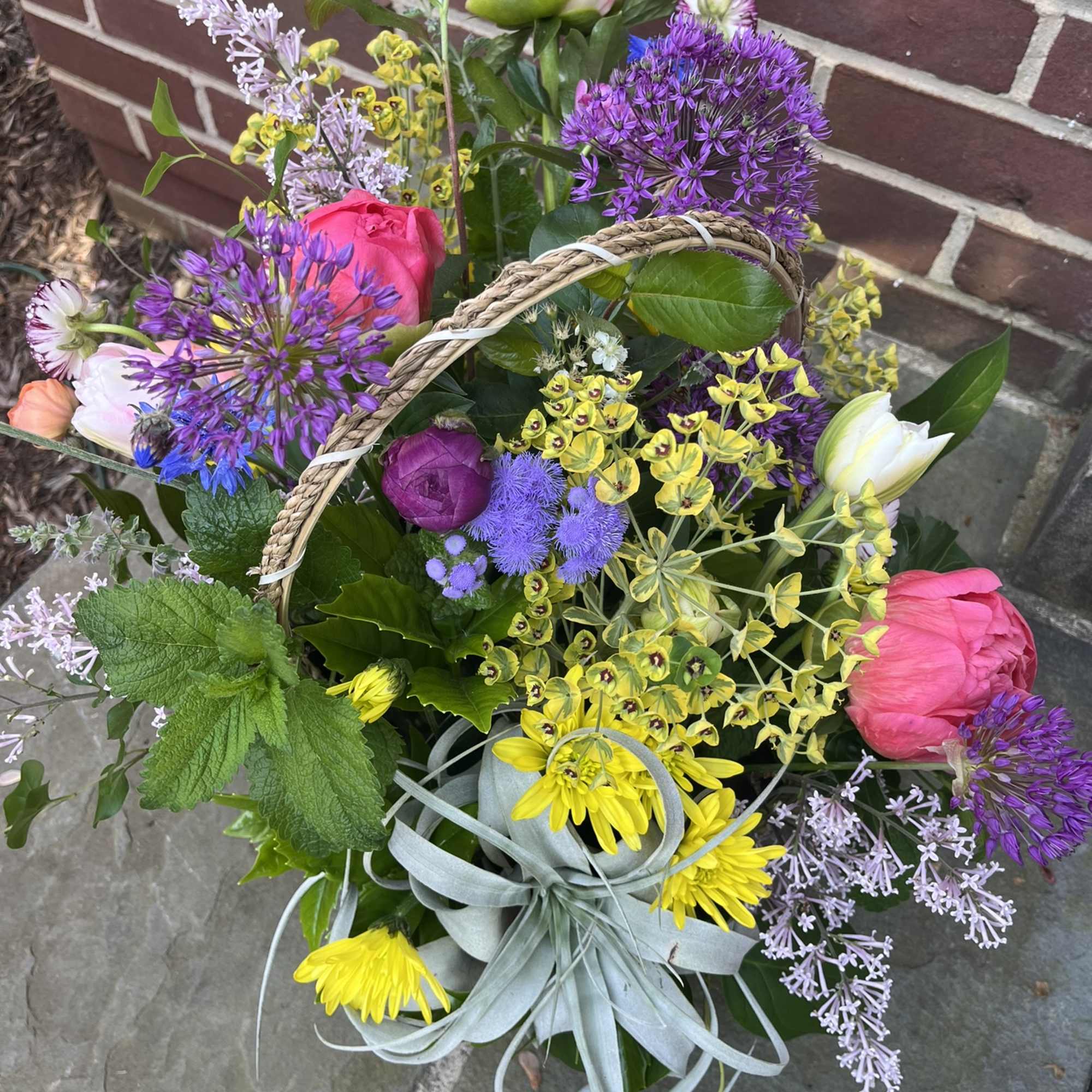 Colorful mixed bouquet with pink peonies, purple allium, and yellow flowers