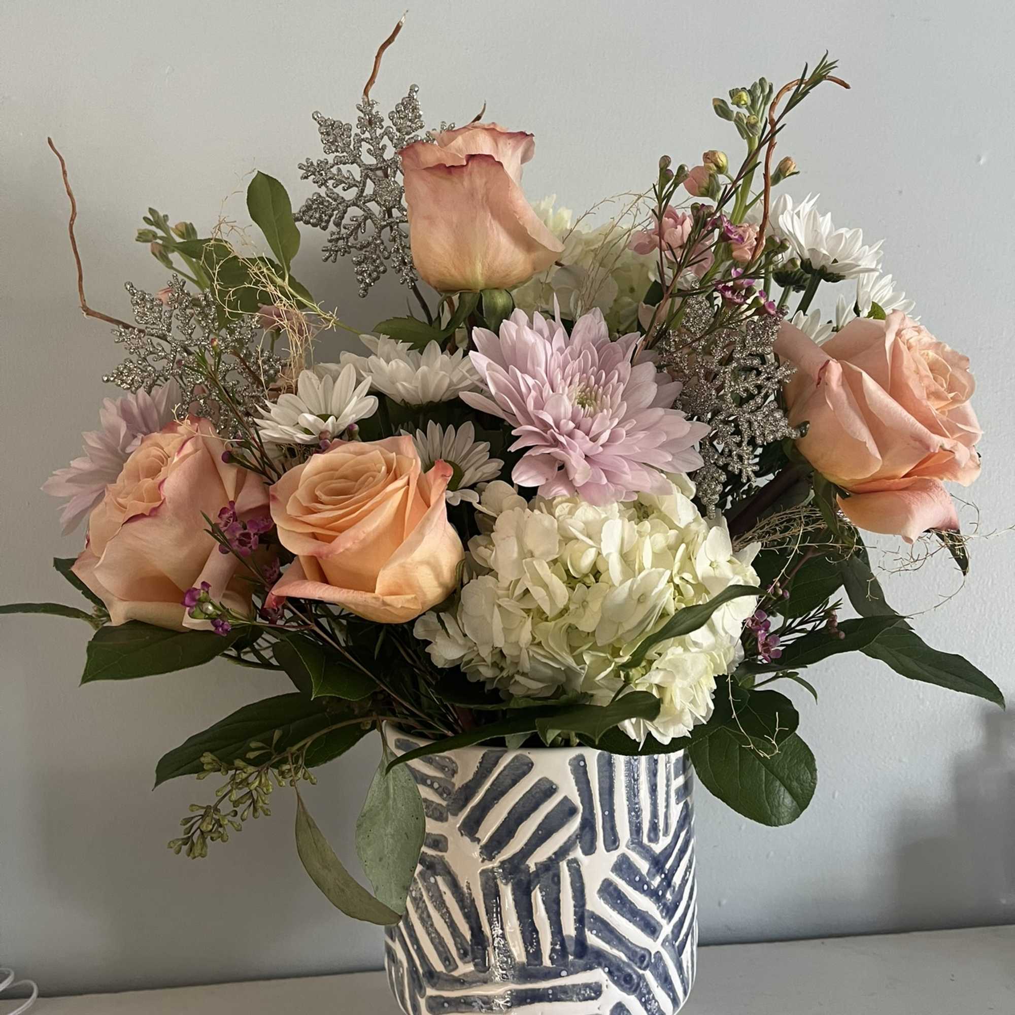 This is a medium height arrangement filled with white and pastel colors.