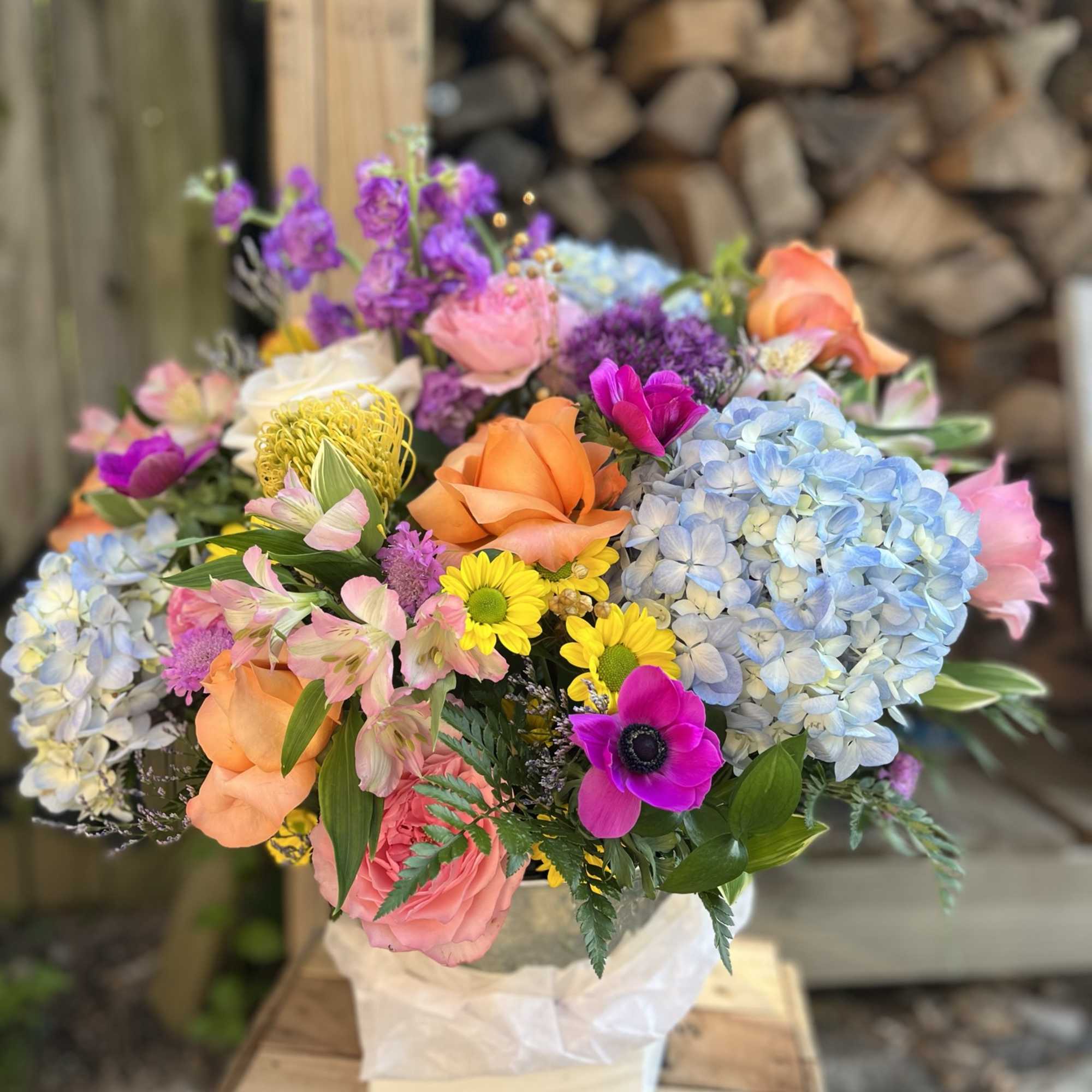 This is a medium height arrangement filled with white and pastel colors.