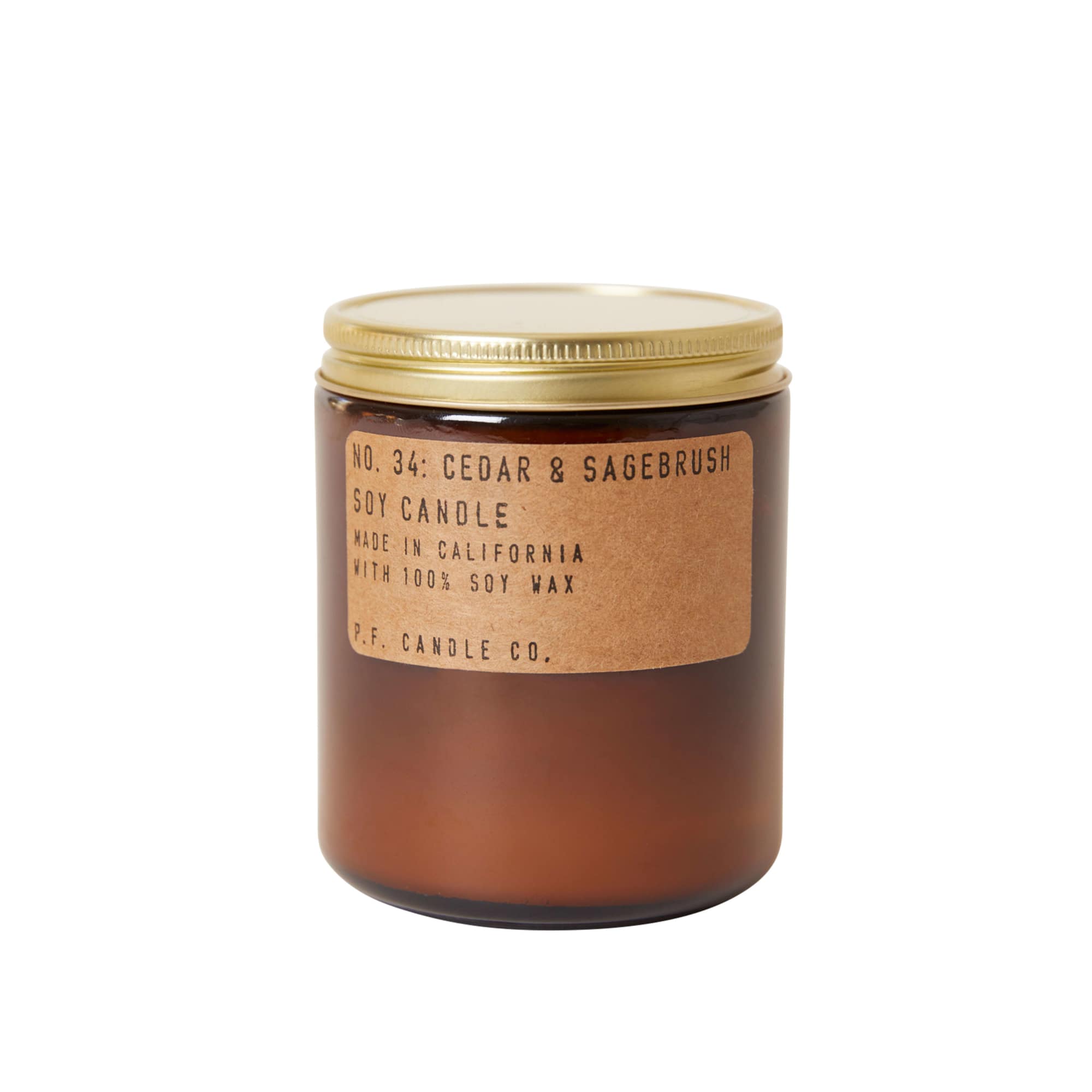 Brown glass candle jar with a gold lid and label