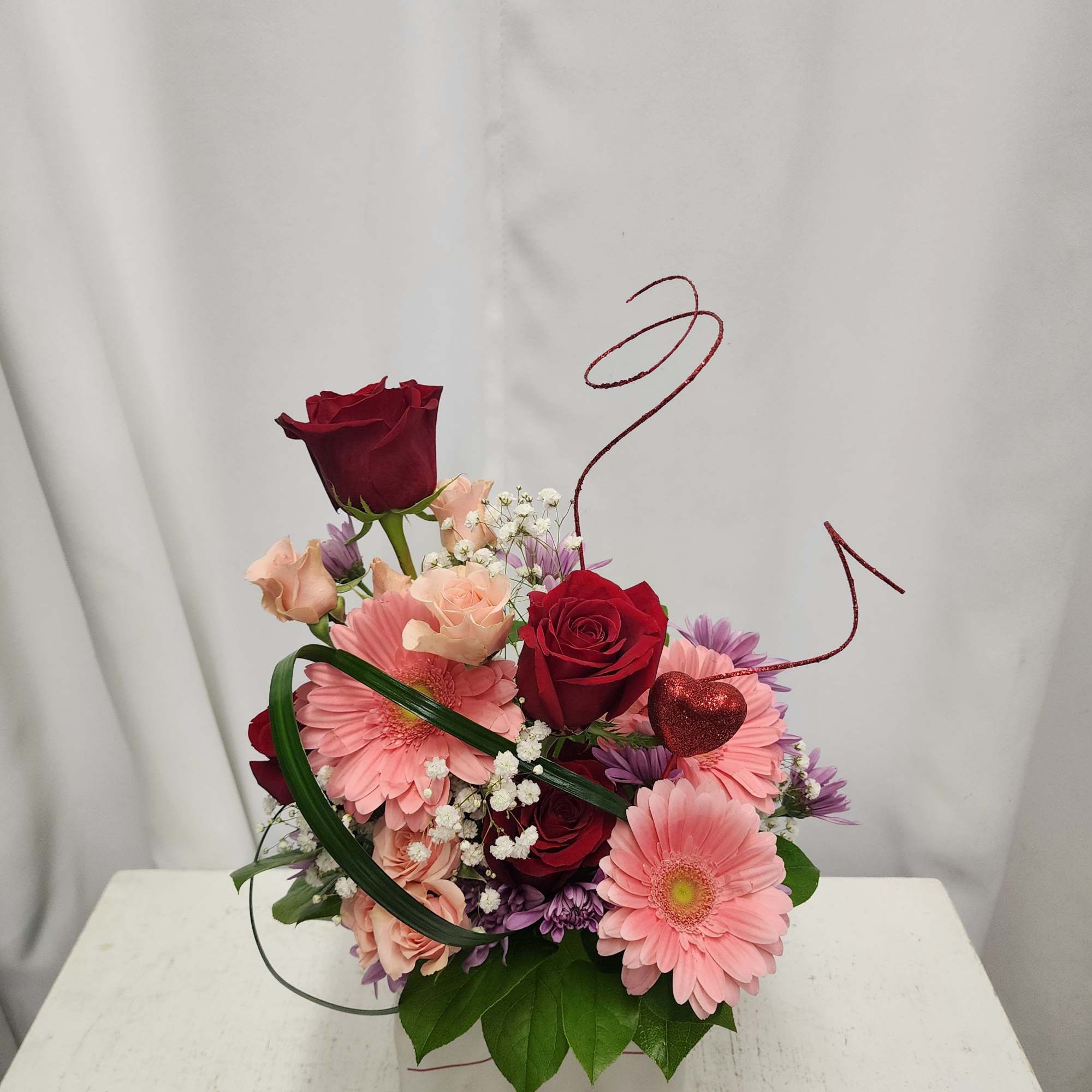 Pink and red rose bouquet with gerbera daisies in a white box