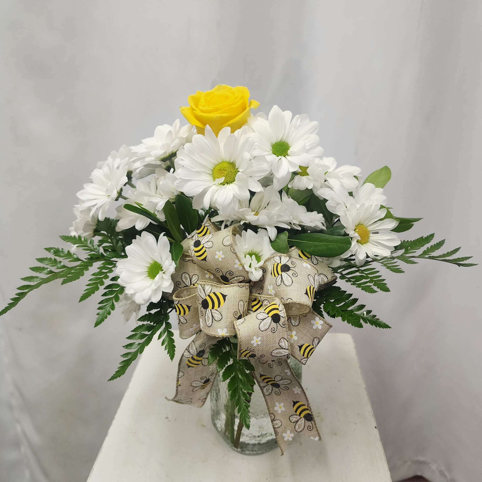 Brighten someone's day with this simple, adorable, and cheery arrangement. Bright white