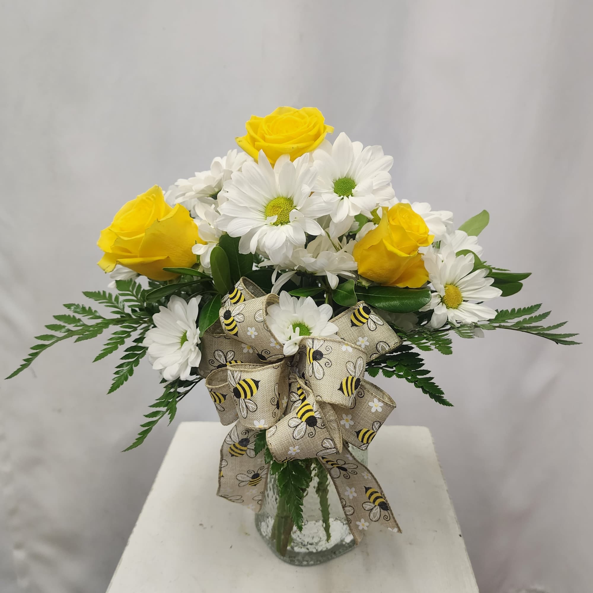 Brighten someone's day with this simple, adorable, and cheery arrangement. Bright white
