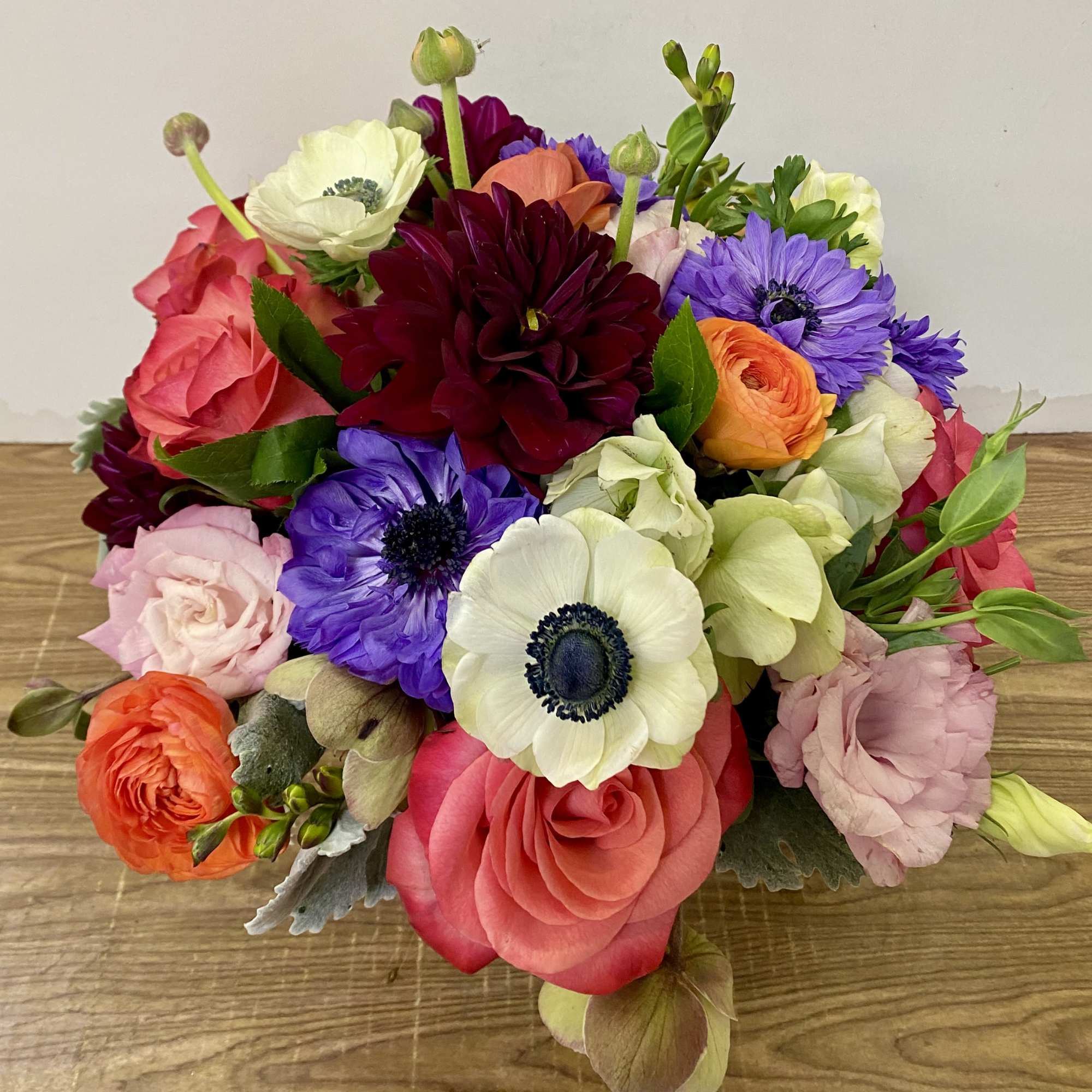 In a clear glass vase combinations of dahlia,  garden roses, tulips, photo 2 of 3