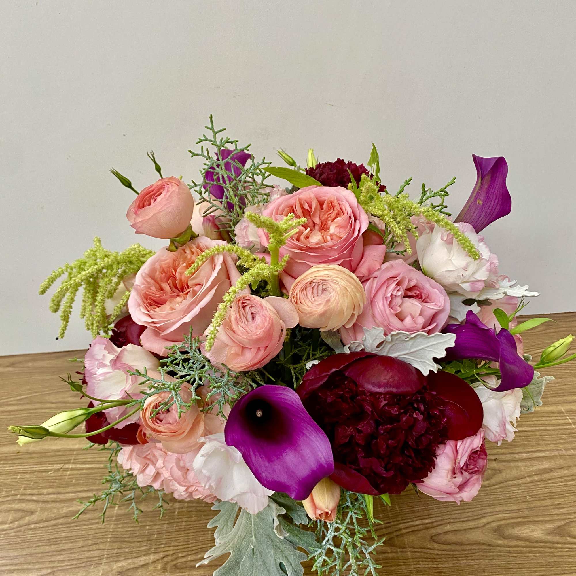 Mixed bouquet of pink and purple flowers with calla lilies and roses