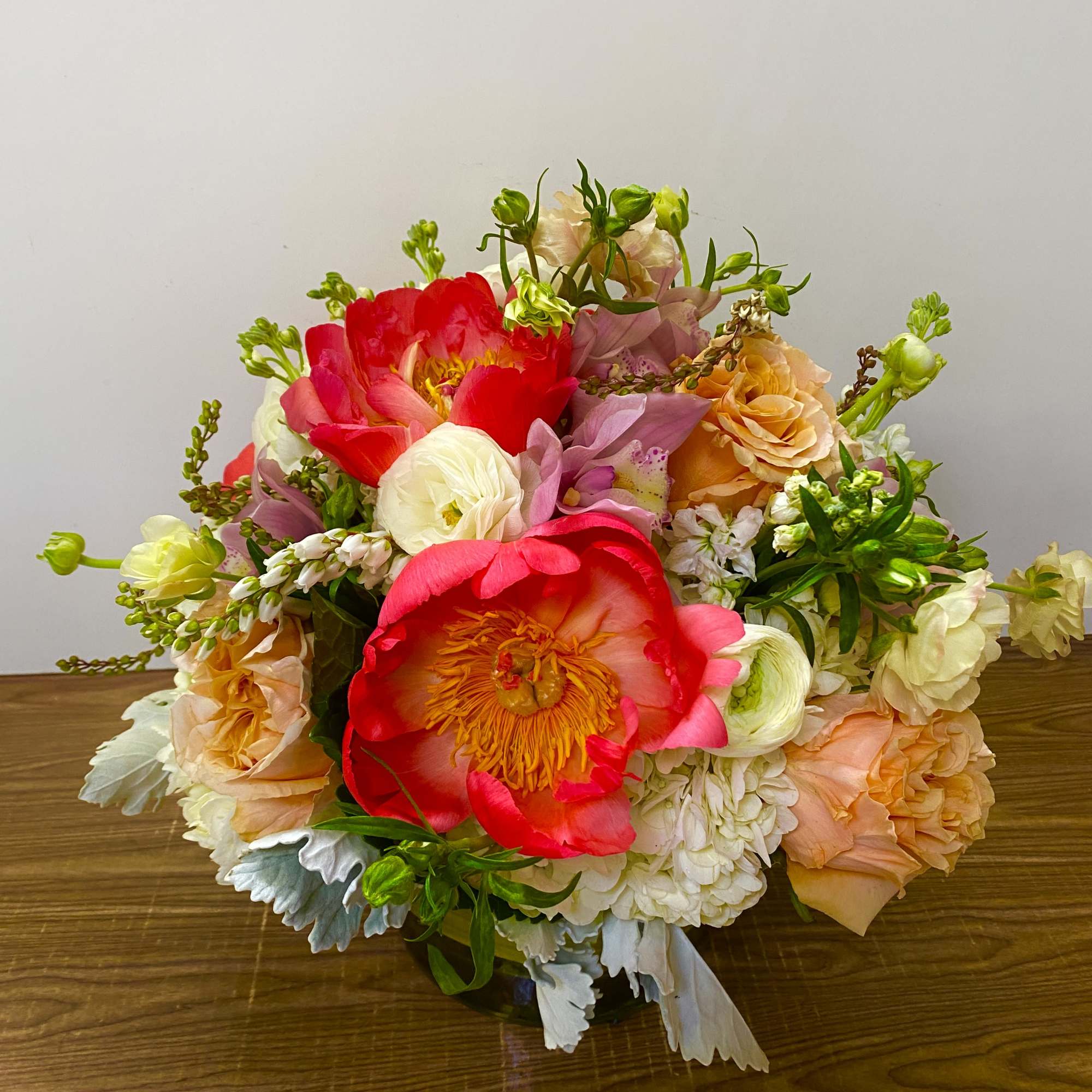 Colorful bouquet of mixed flowers on a wooden table