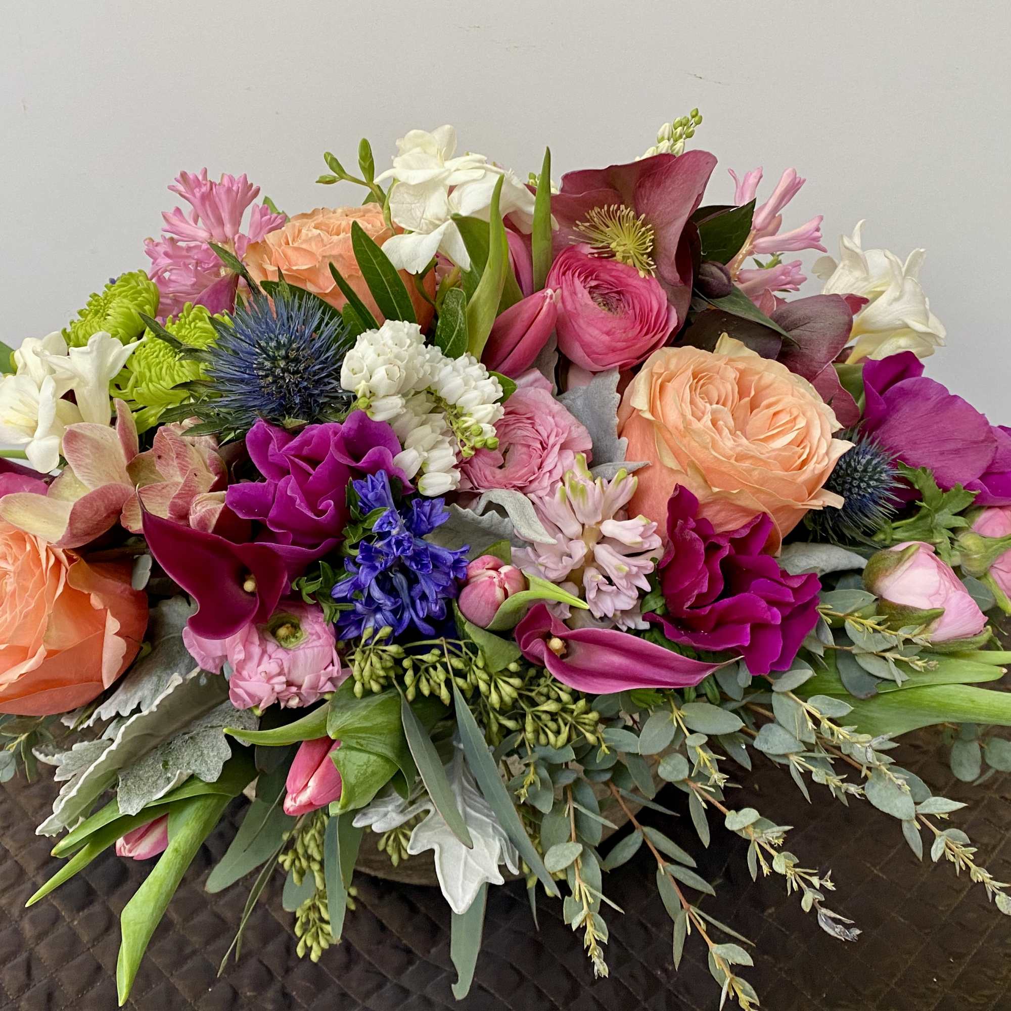 Mixed bouquet with peach roses, pink blooms, and white flowers