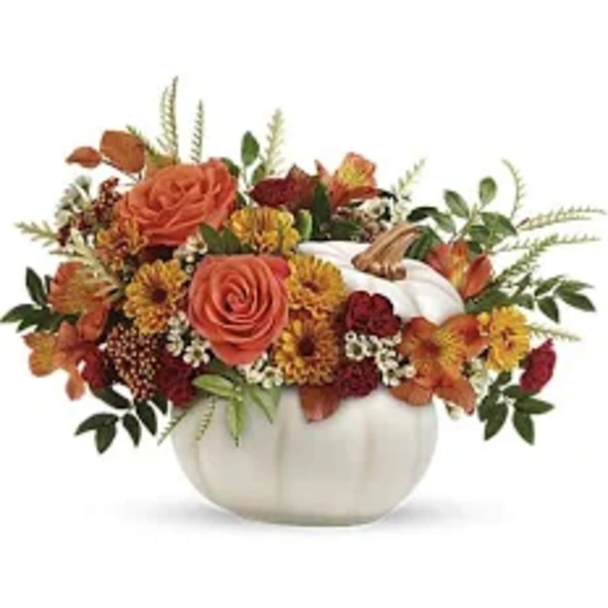 Orange roses and autumn flowers arranged in a white pumpkin vase