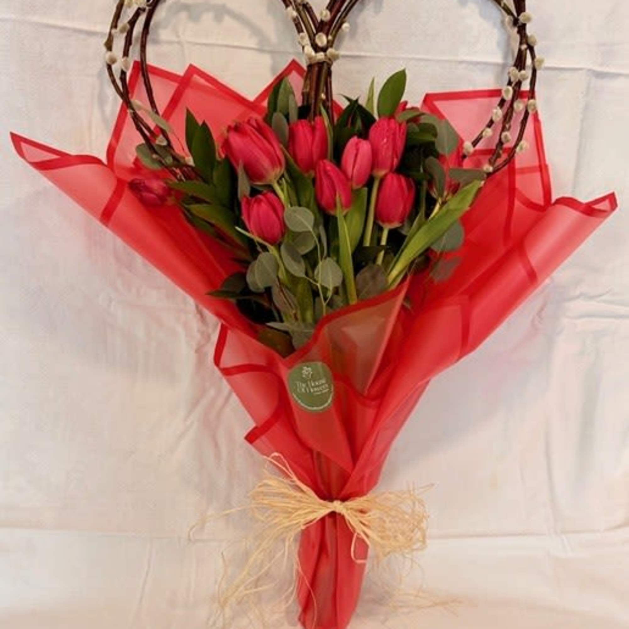 A beautiful bouquet of tulips with a natural heart-shaped base, perfect for