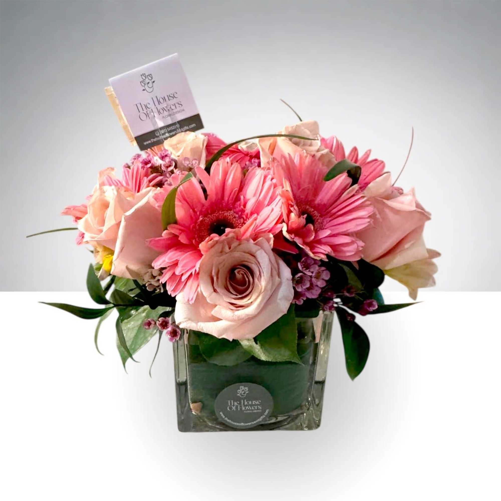 A romantic blend of premium roses and fresh seasonal blooms designed in
