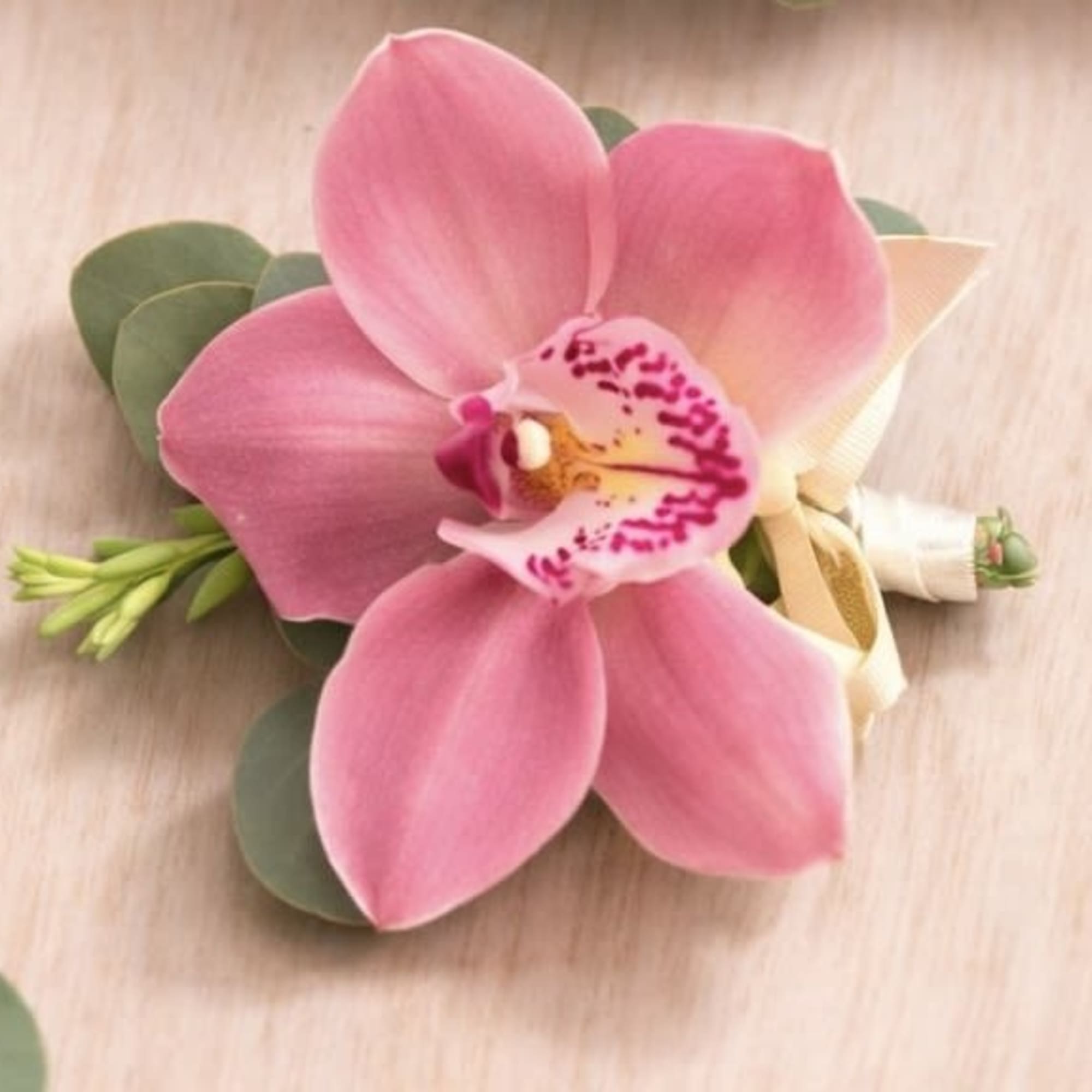A refined and elegant boutonniere featuring a fresh orchid bloom, accented with, photo 2 of 3