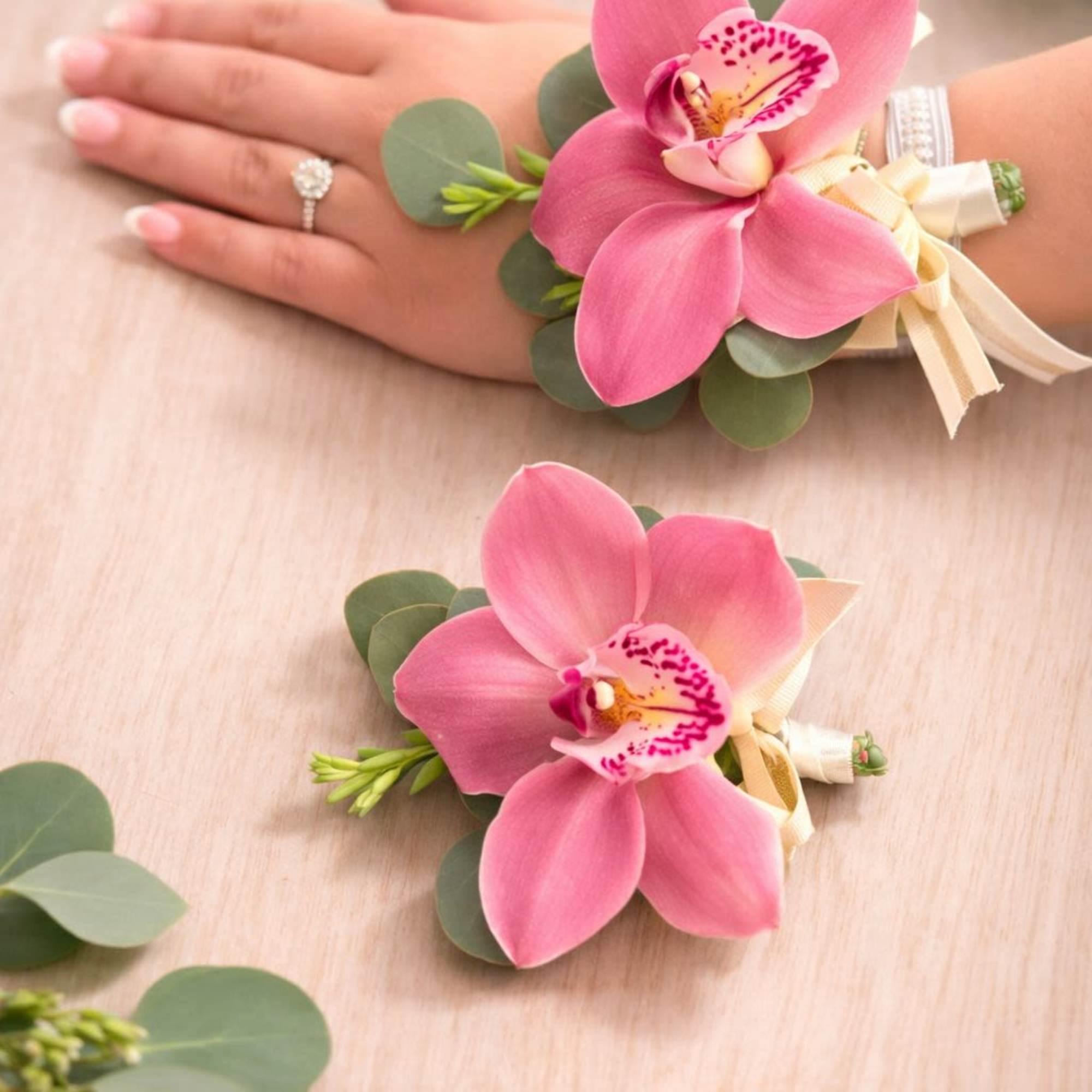 A beautifully coordinated set featuring an elegant orchid wrist corsage and a, photo 2 of 3
