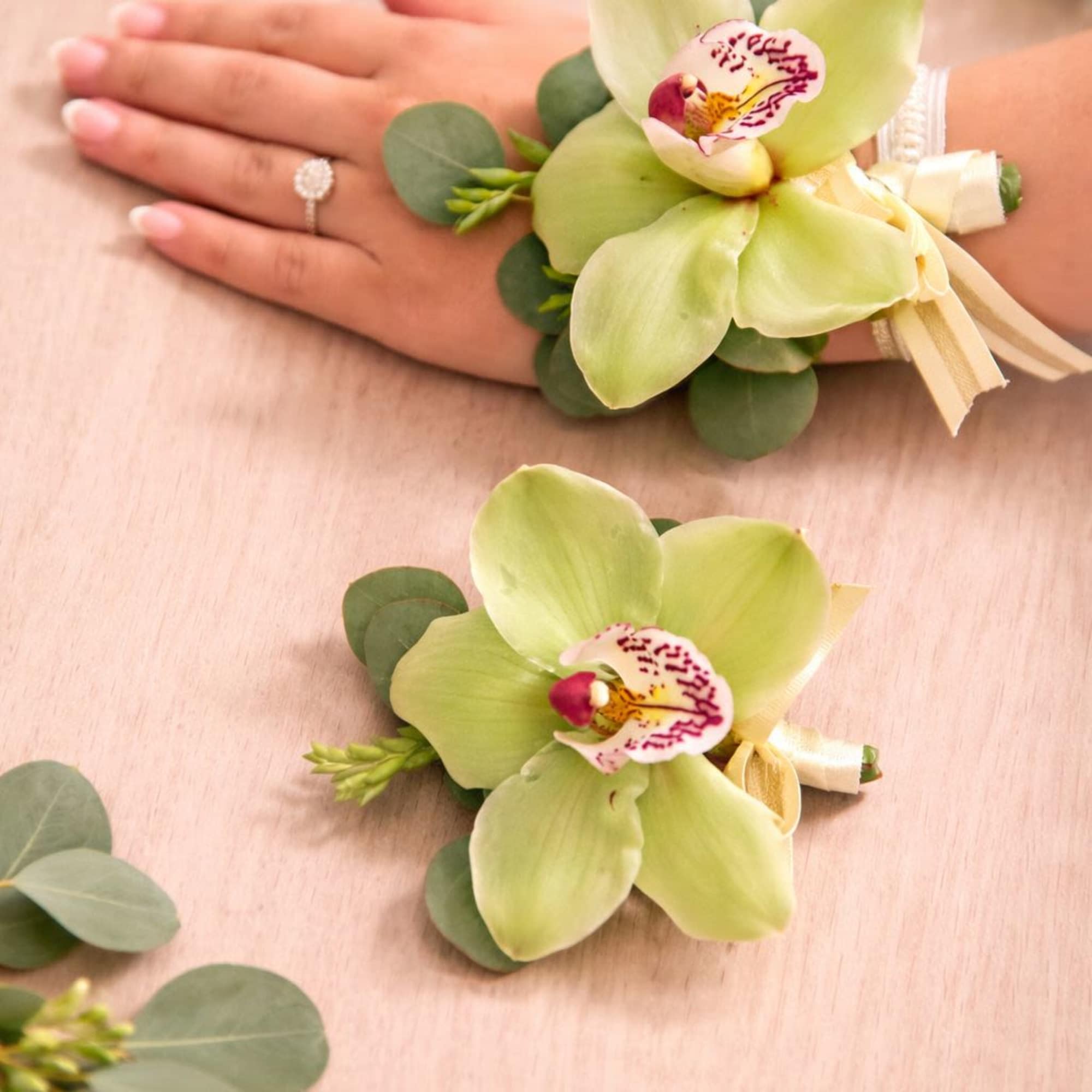 A beautifully coordinated set featuring an elegant orchid wrist corsage and a, photo 3 of 3