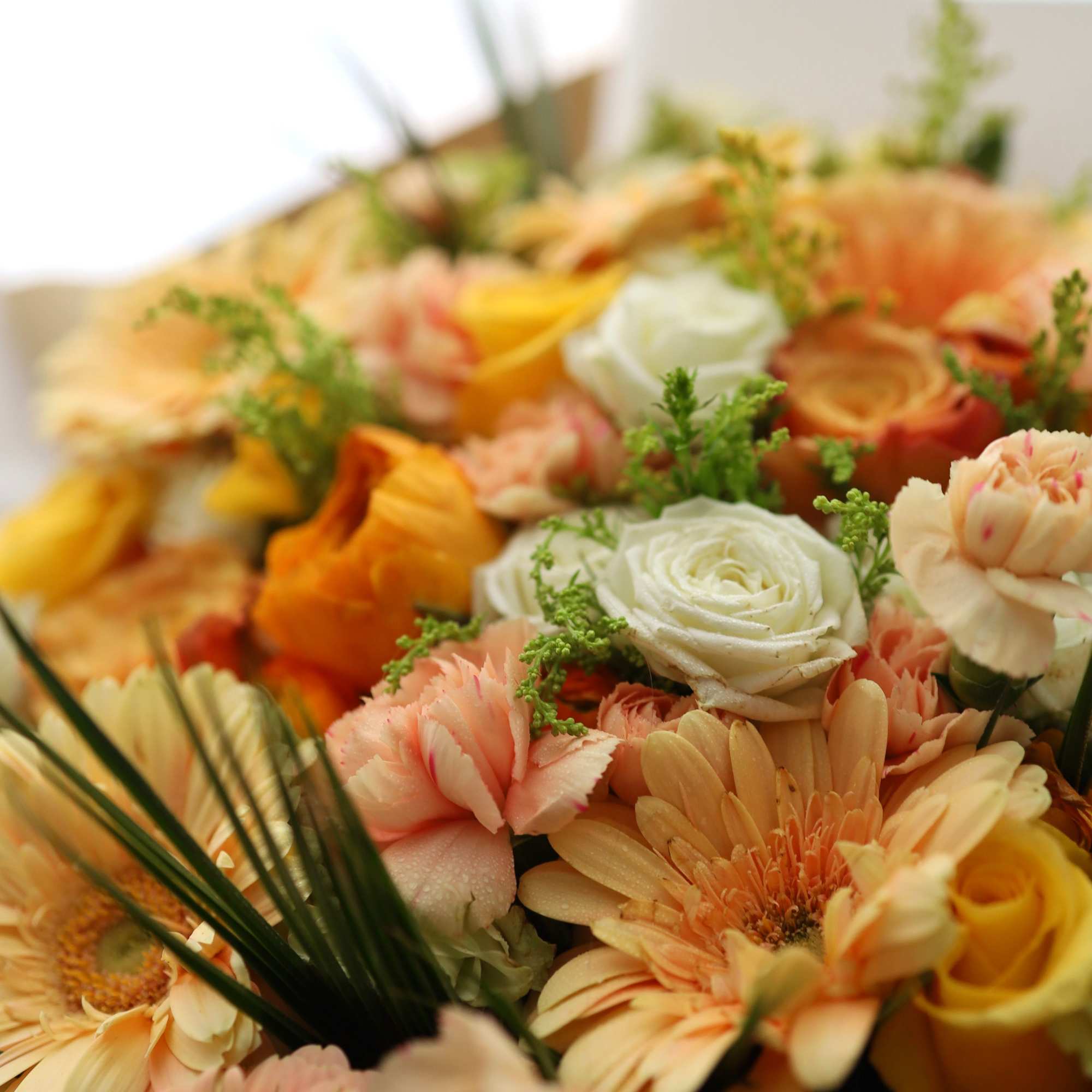 Peach and white mixed flower bouquet with orange blooms