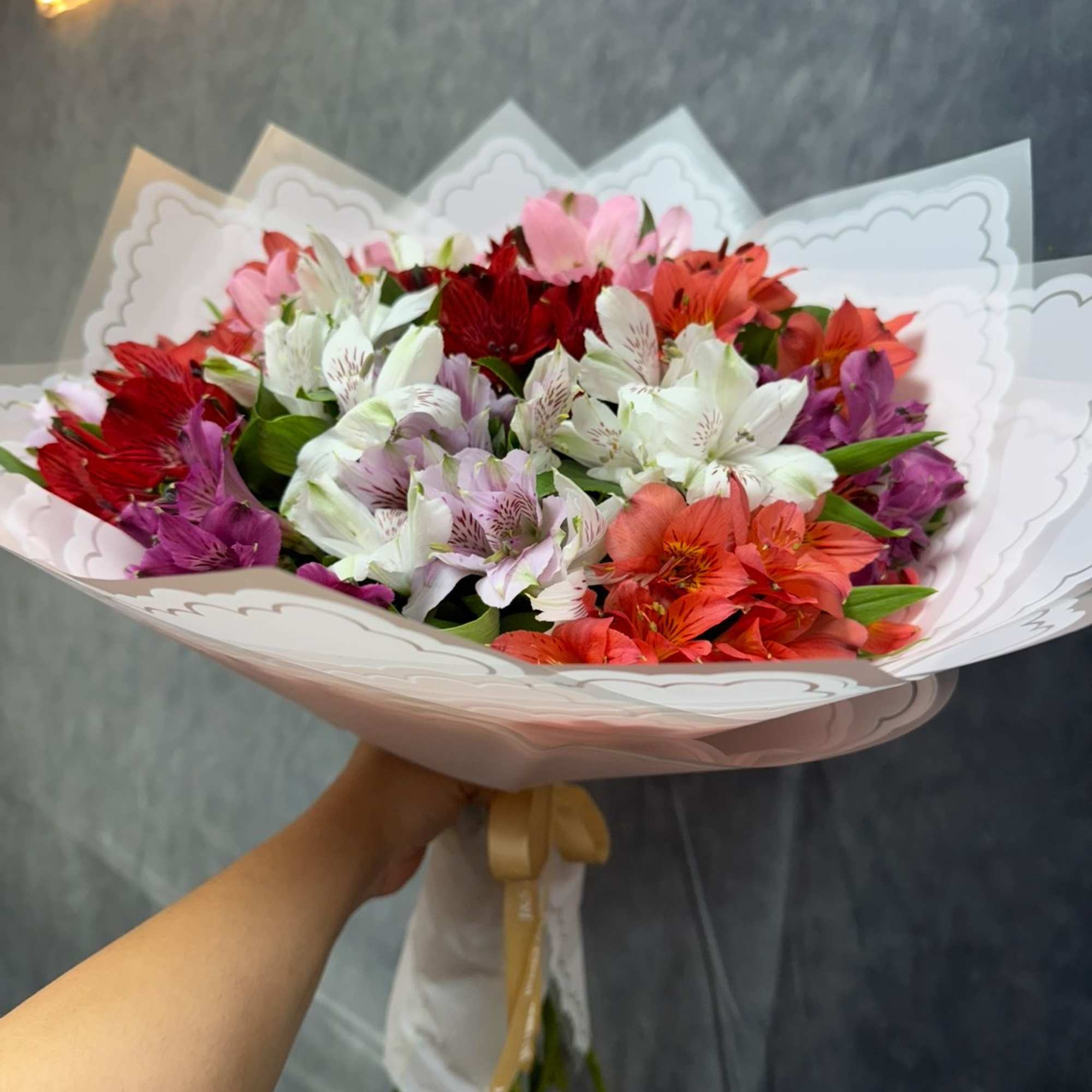 Bouquet of multicolored alstroemeria wrapped in white paper