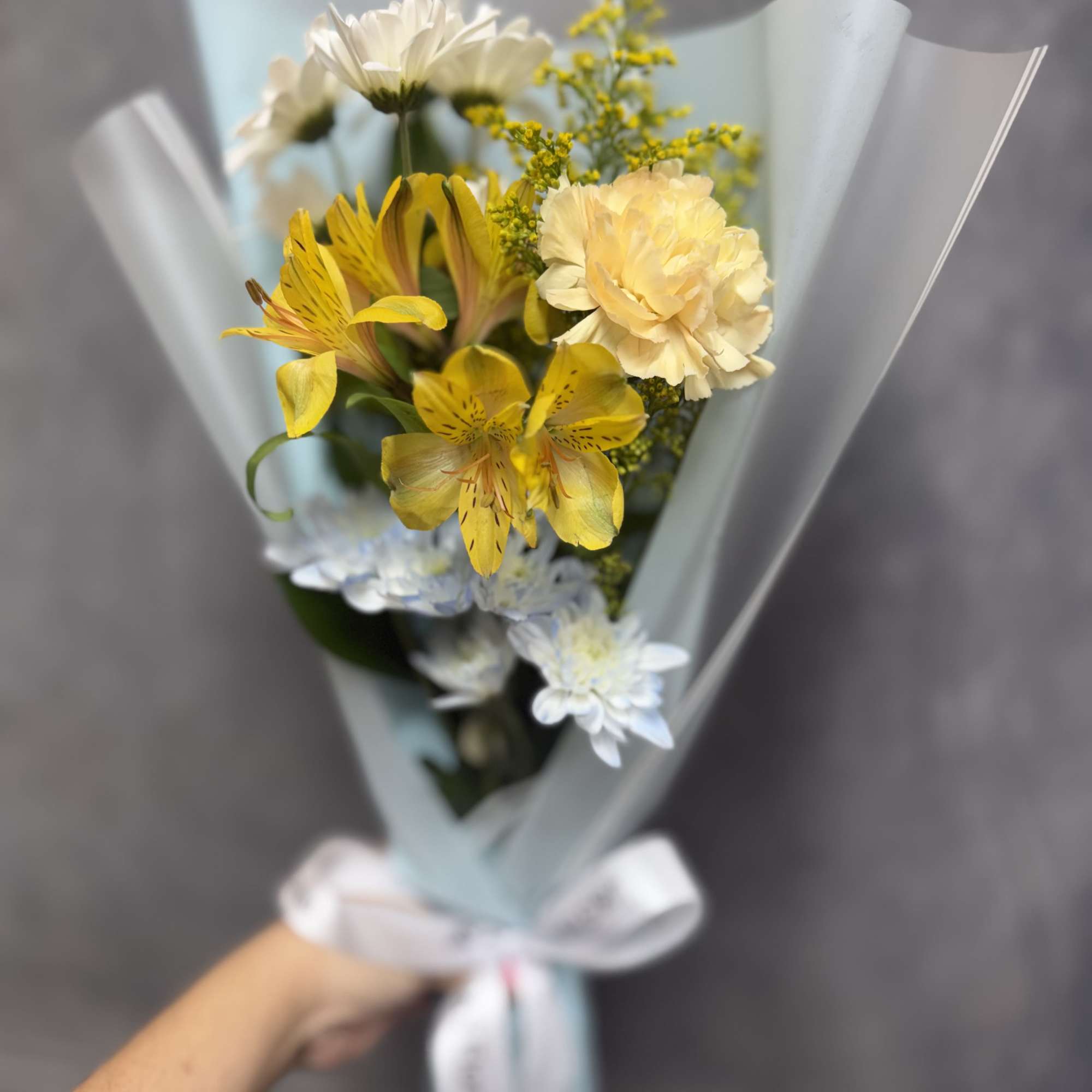 White daisies, with baby blue , carnations and alstroemeria wrapped in soft