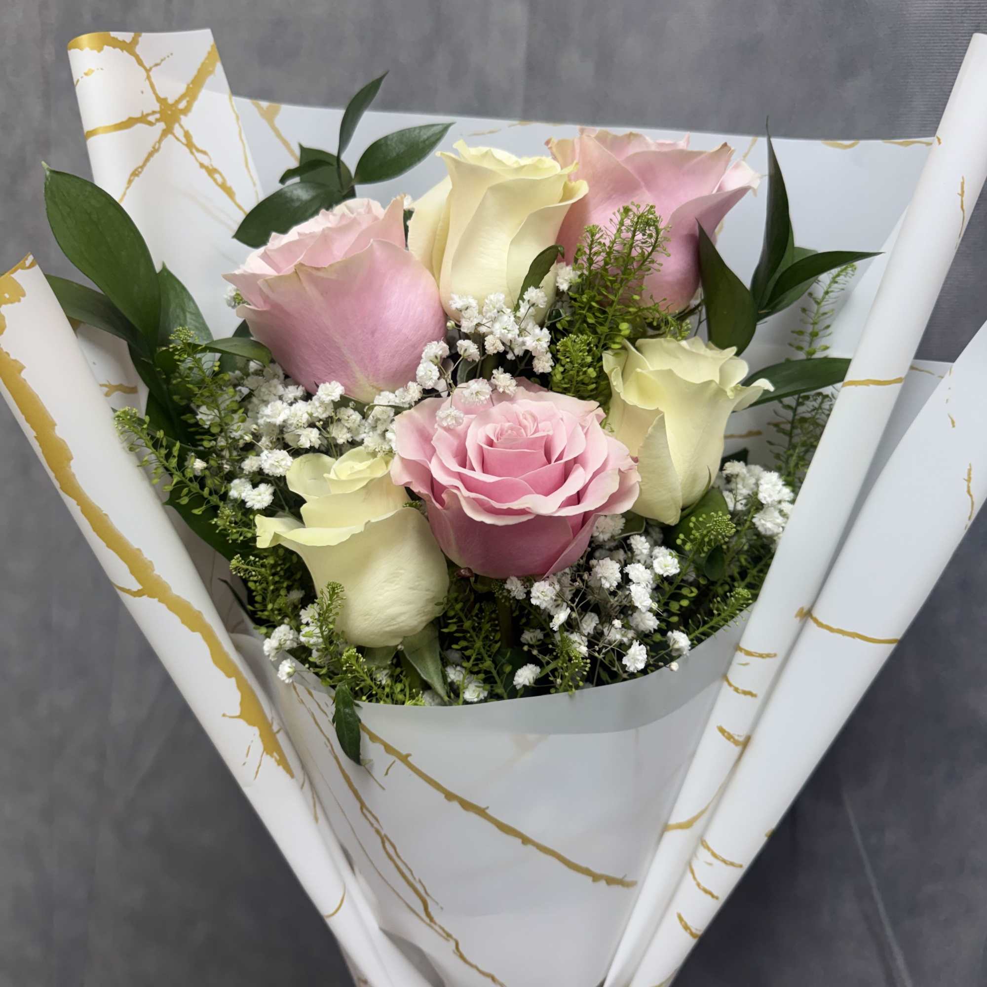 Half dozen layered Pink and white roses with baby&rsquo;s breath wrapped in