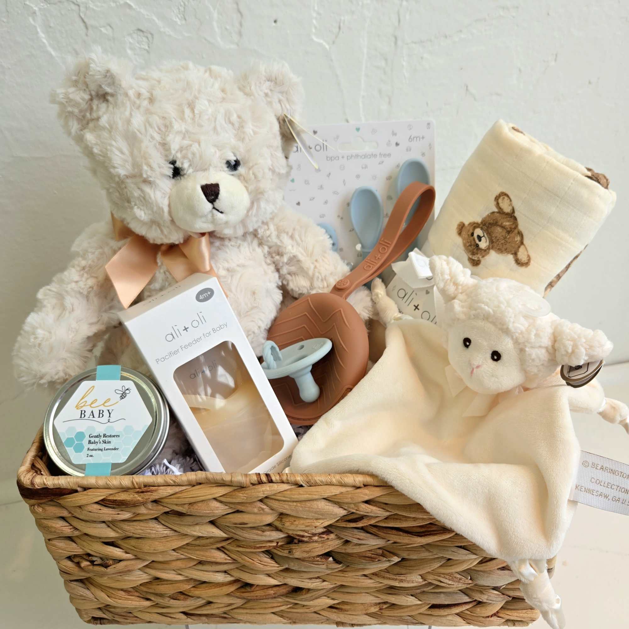 Baby gift basket with teddy bears, blanket, pacifier, and feeding items