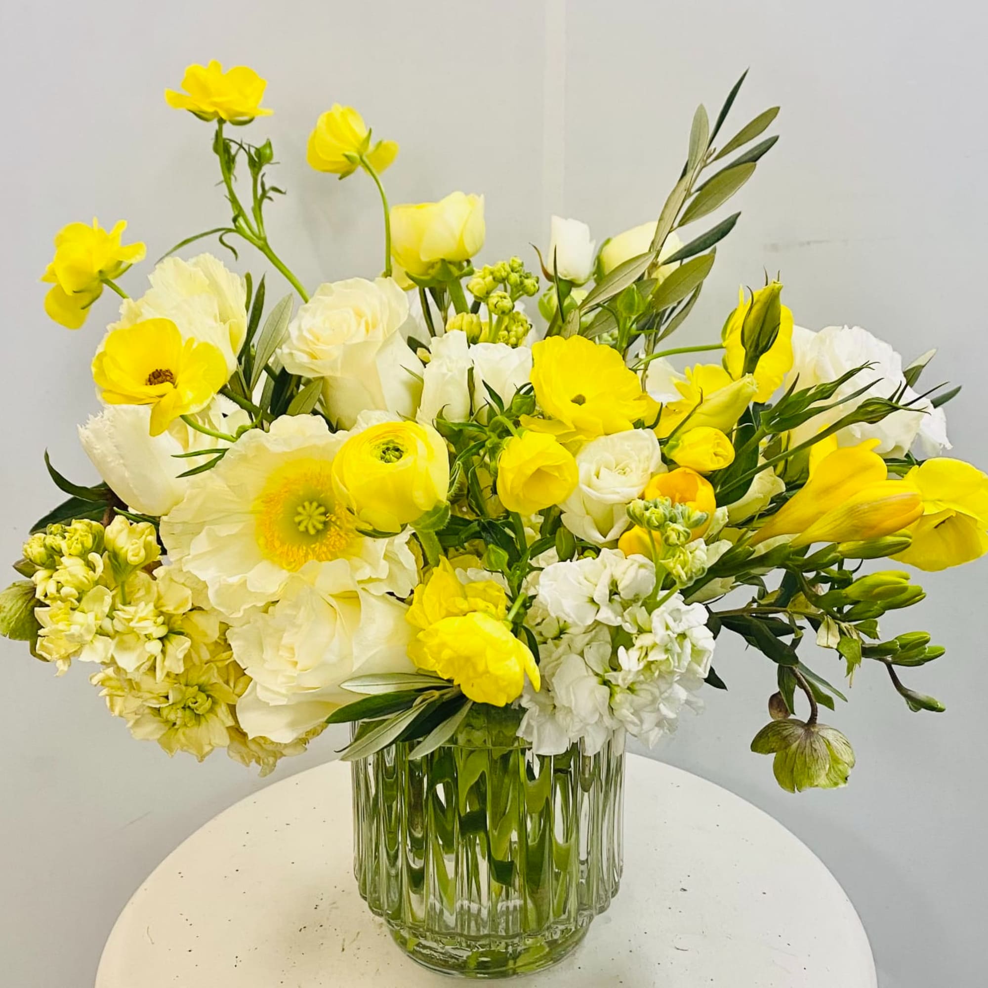 Yellow and white mixed bouquet in a clear glass vase