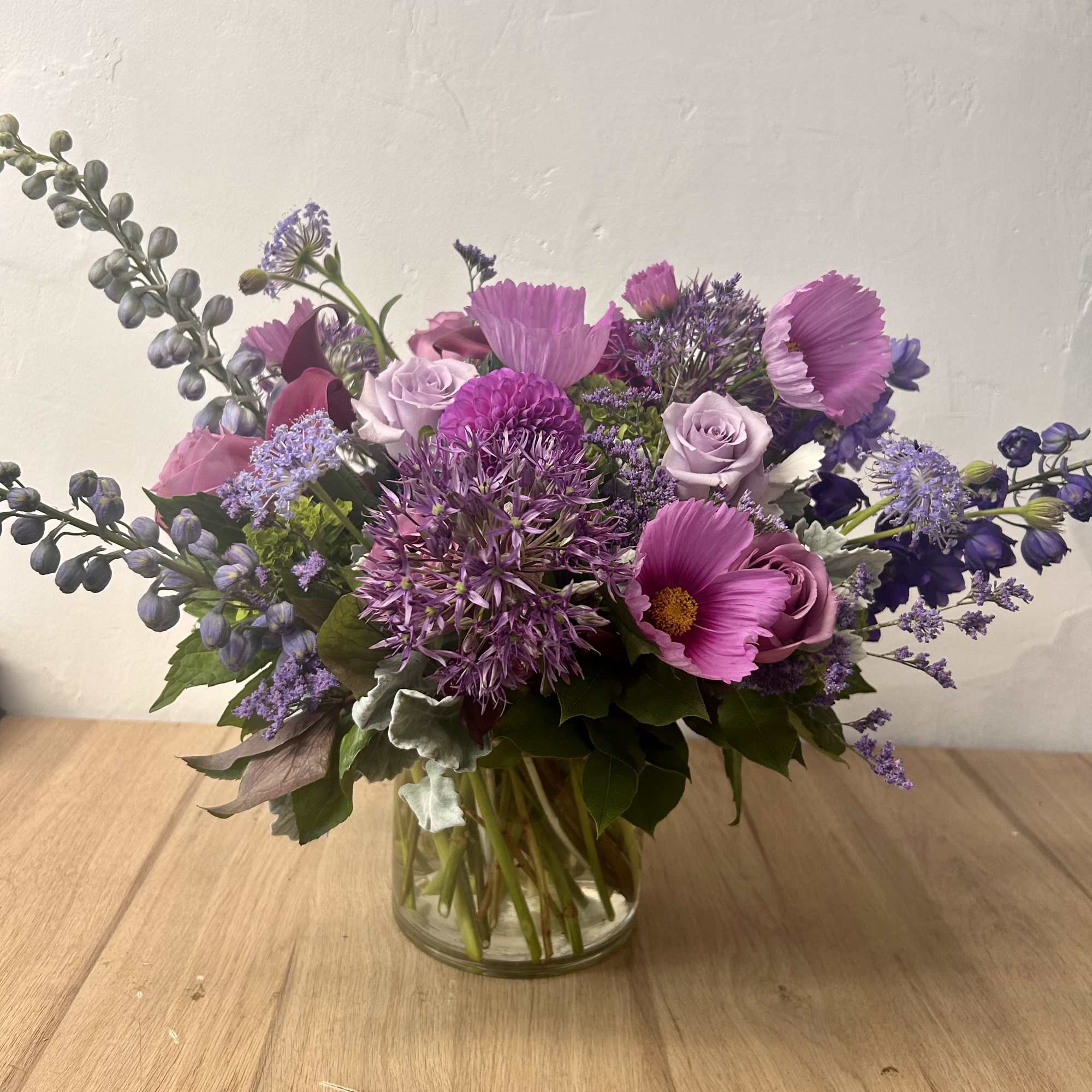 Purple mixed bouquet in a clear glass vase