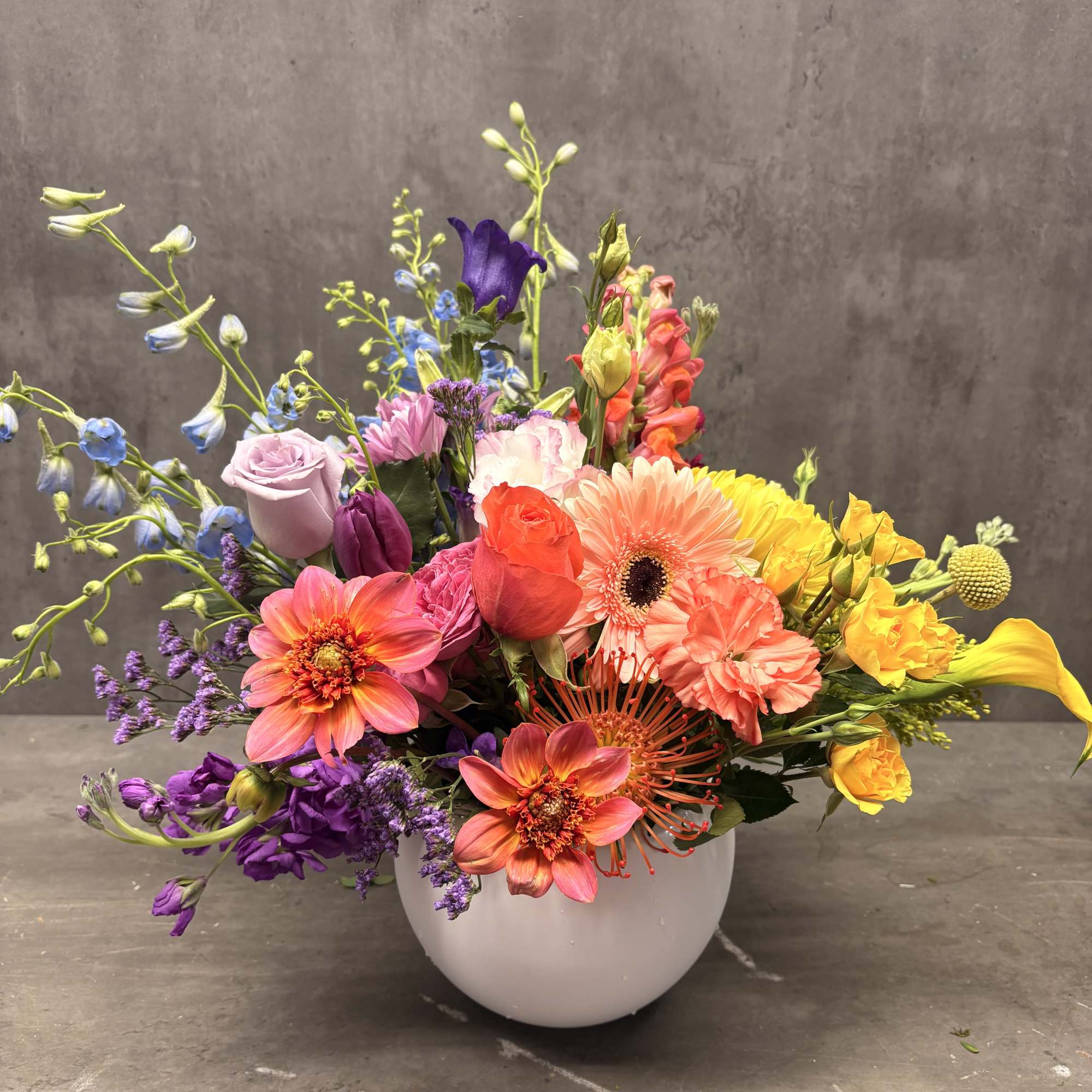 Colorful mixed bouquet in a white round vase