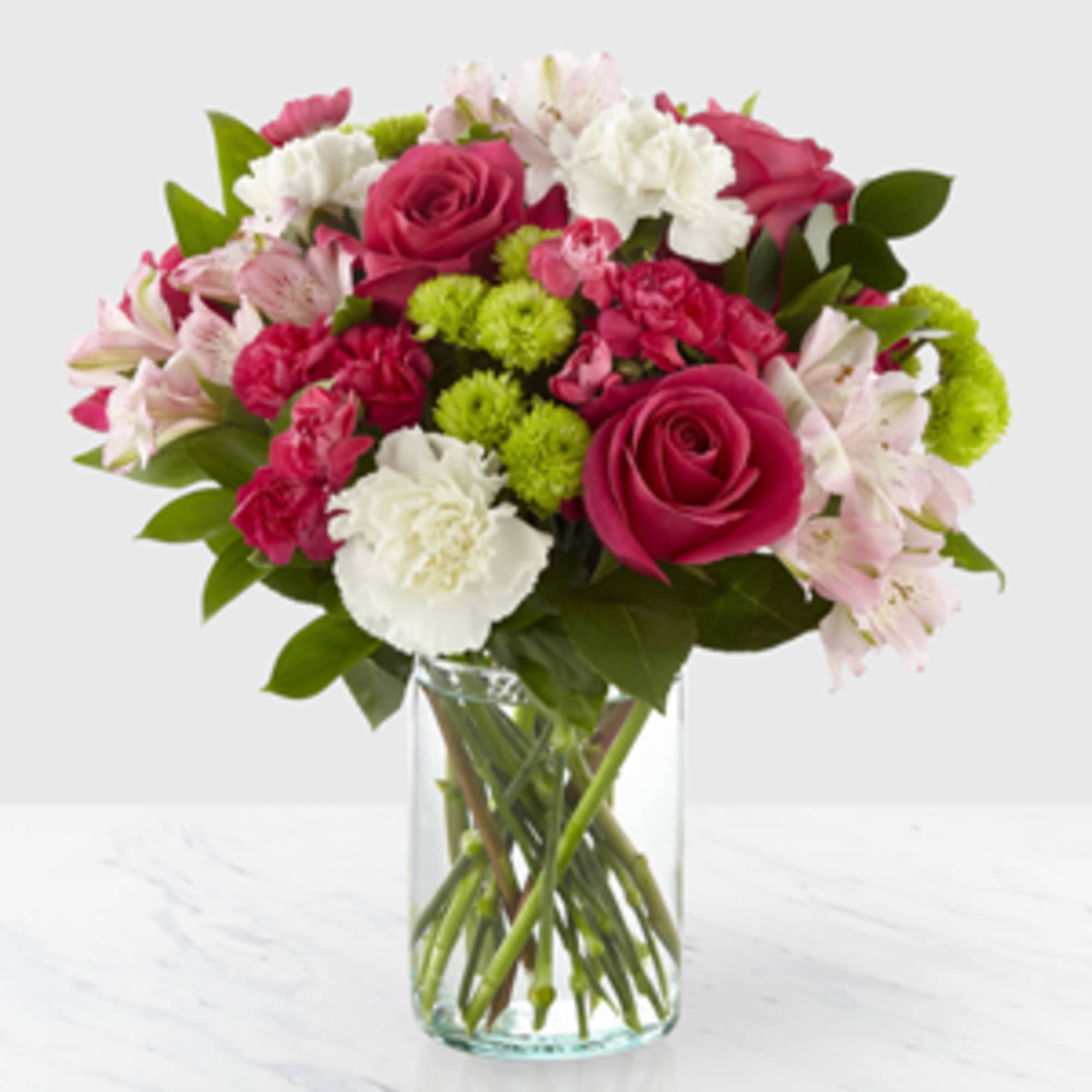 Bouquet of pink and white flowers in a clear glass vase