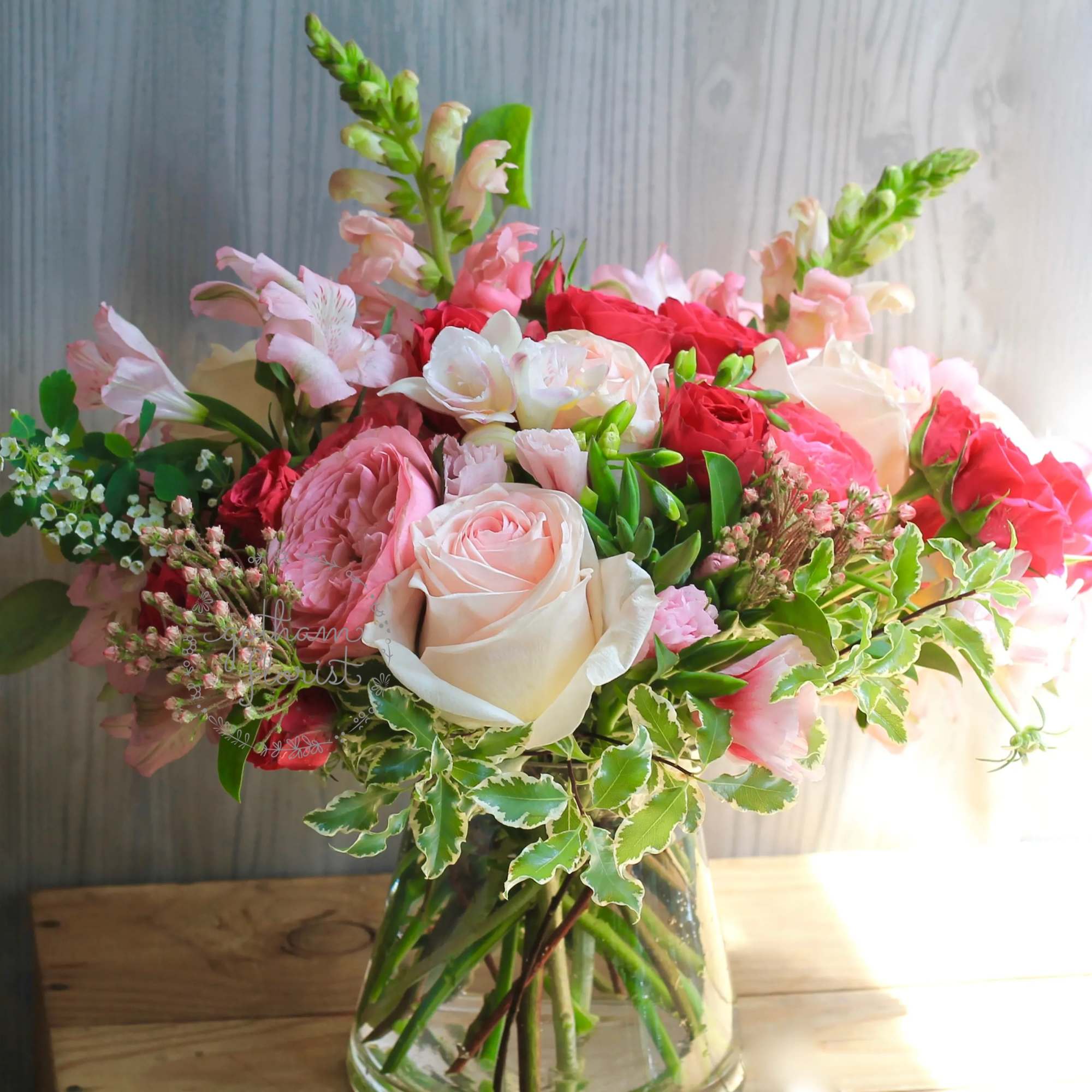 Pink and white rose bouquet in a glass vase