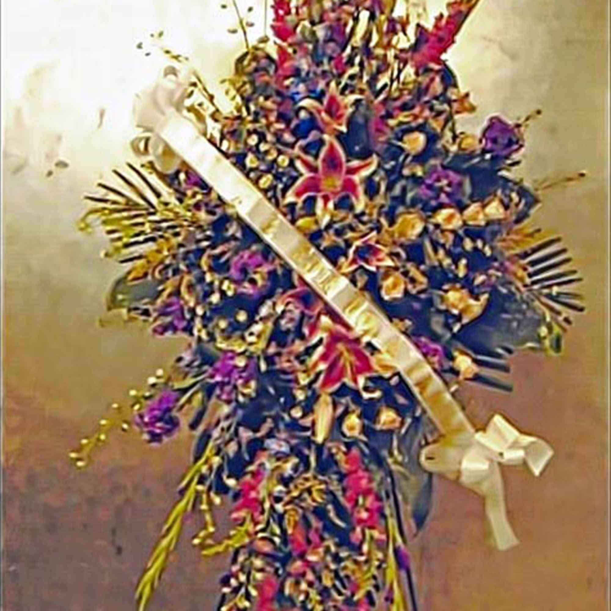 Tall standing spray of multicolored flowers with a diagonal white ribbon and bow