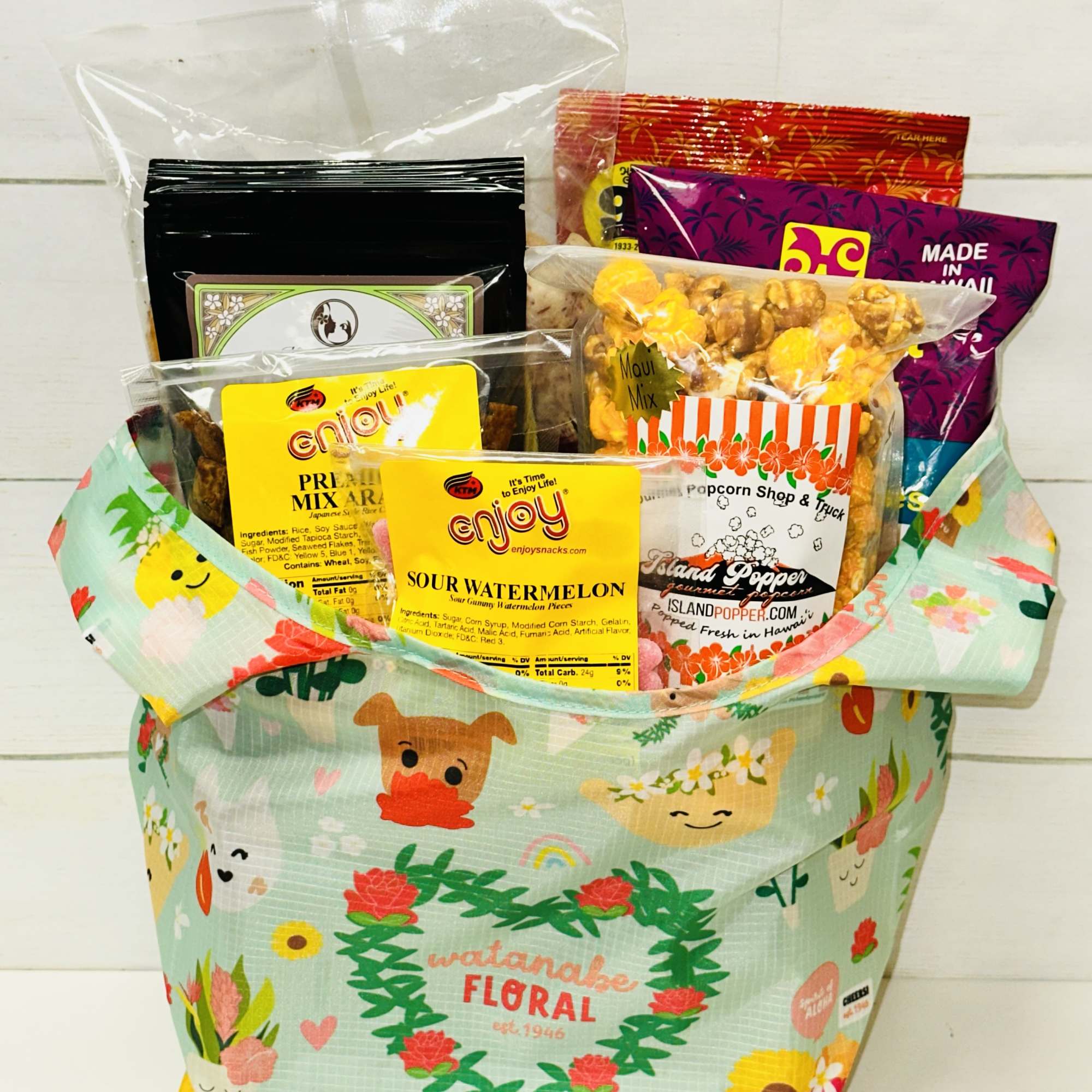 Colorful gift tote filled with assorted packaged snacks and treats