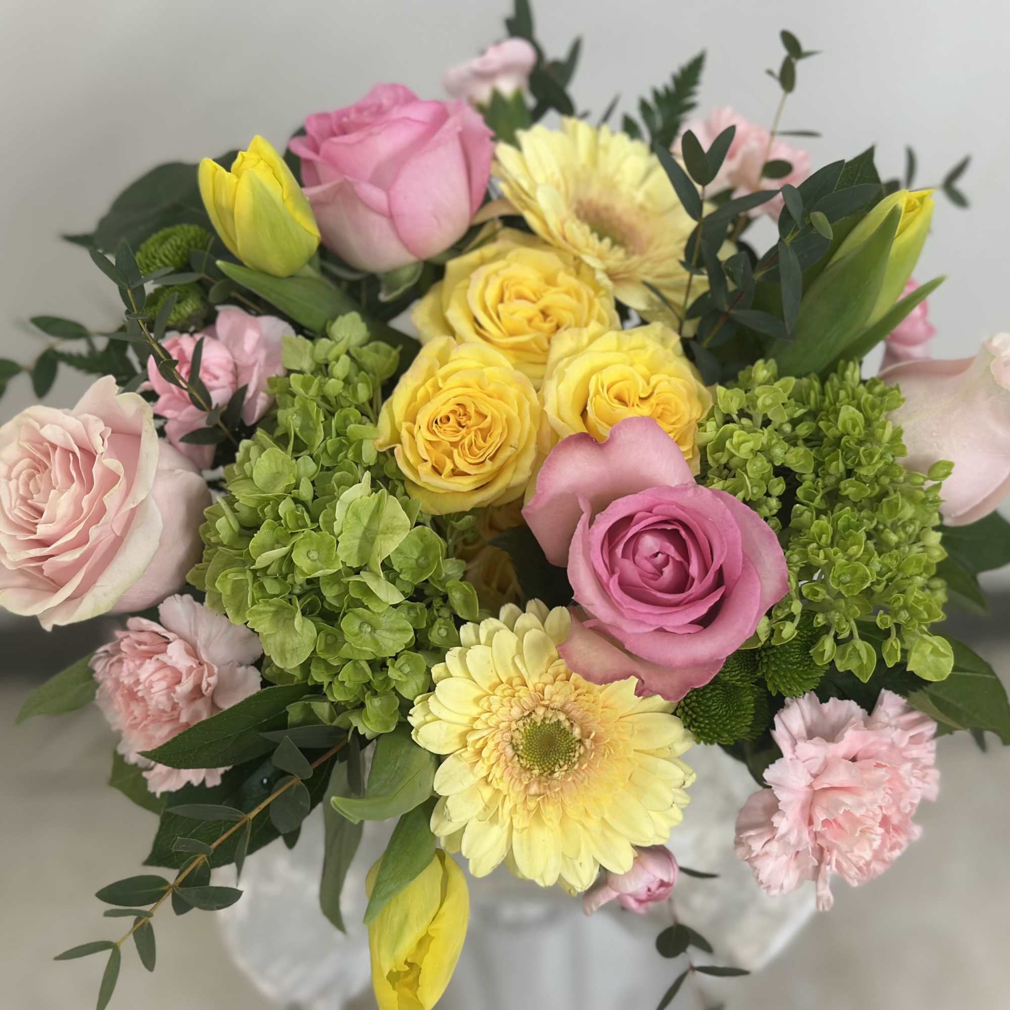 Bouquet of pink and yellow roses with gerbera daisies and carnations