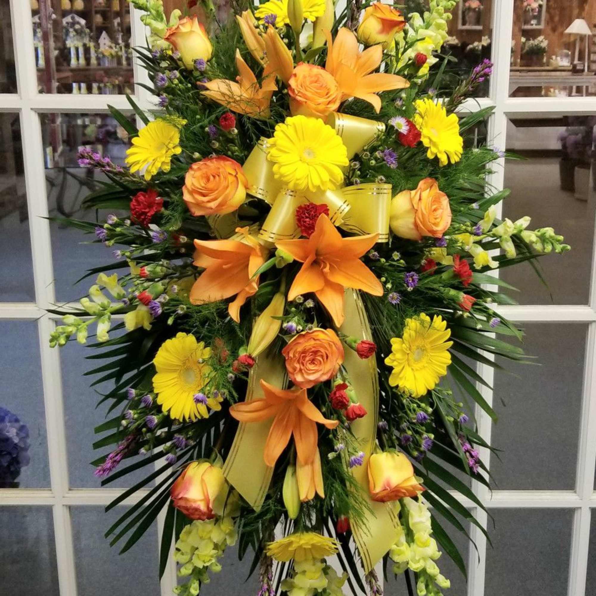 Large standing spray with orange lilies, yellow daisies, and roses