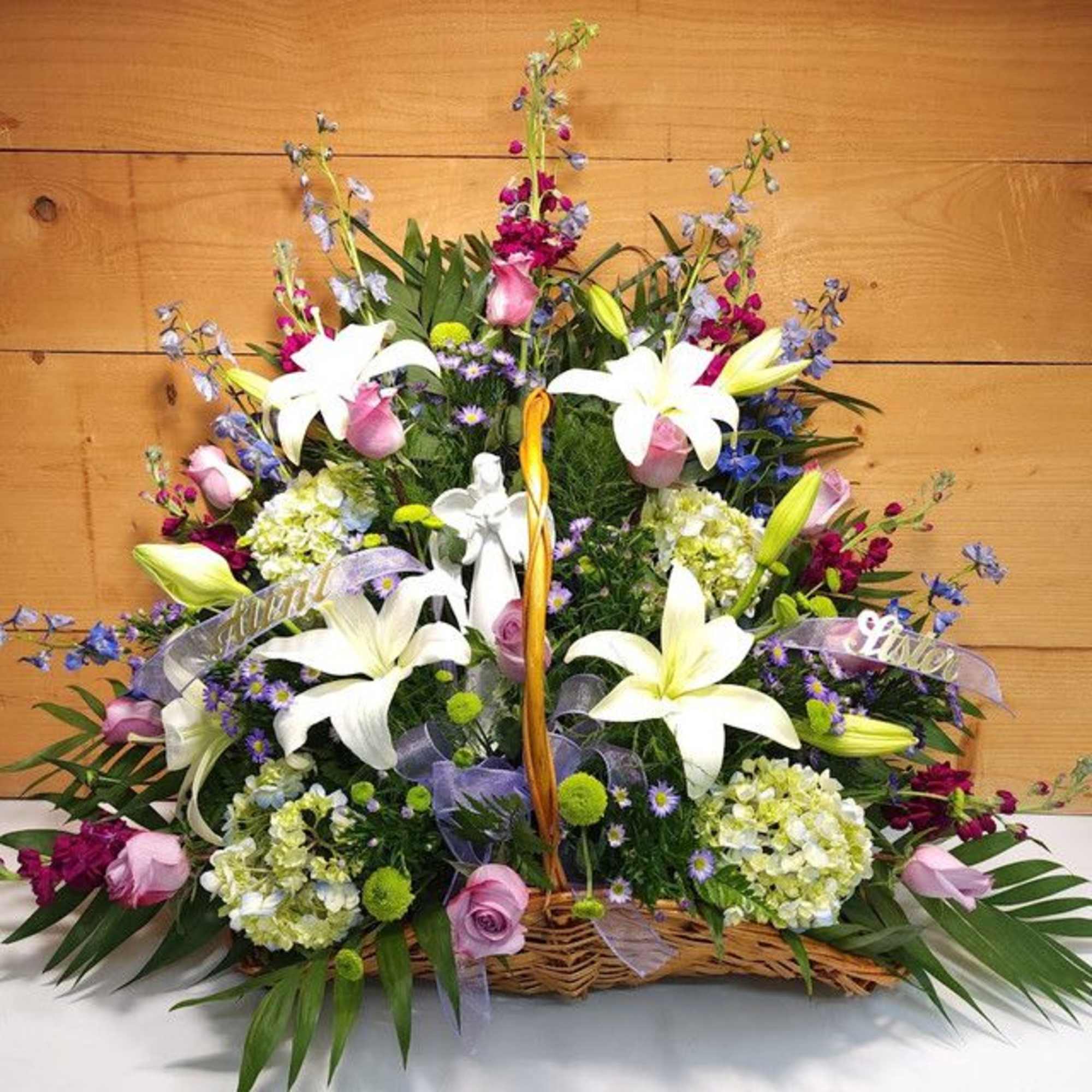 Large basket arrangement with white lilies, pink roses, and purple flowers, photo 3 of 3