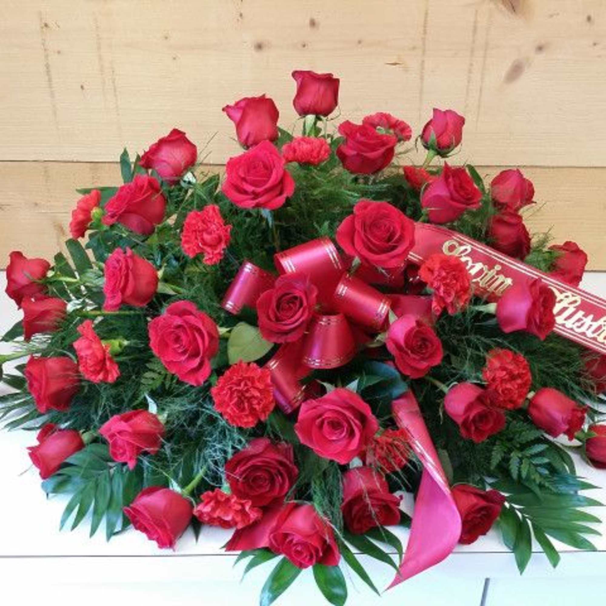 Large red rose arrangement with a ribbon reading "Happy Birthday"