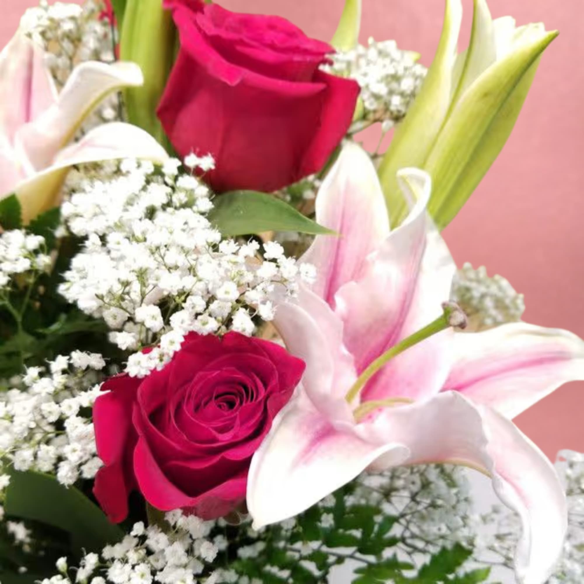 Bouquet of pink roses and white lilies with baby's breath