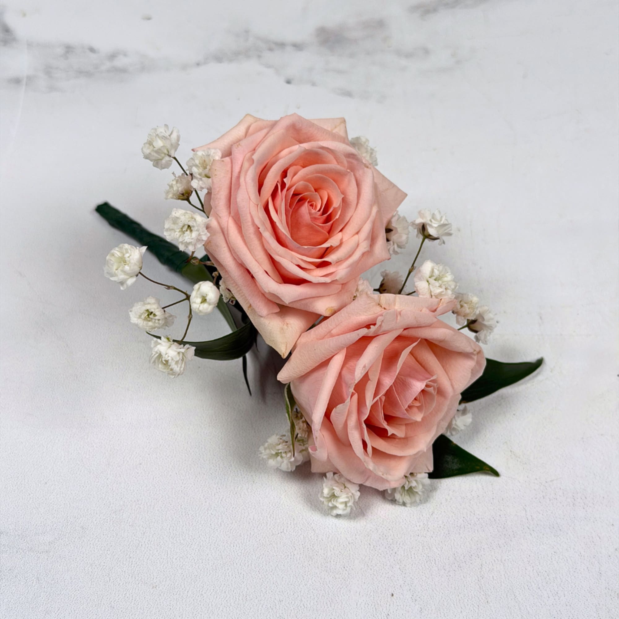 Two pale blush roses sit snugly together in this Rose Quartz boutonniere, photo 2 of 3