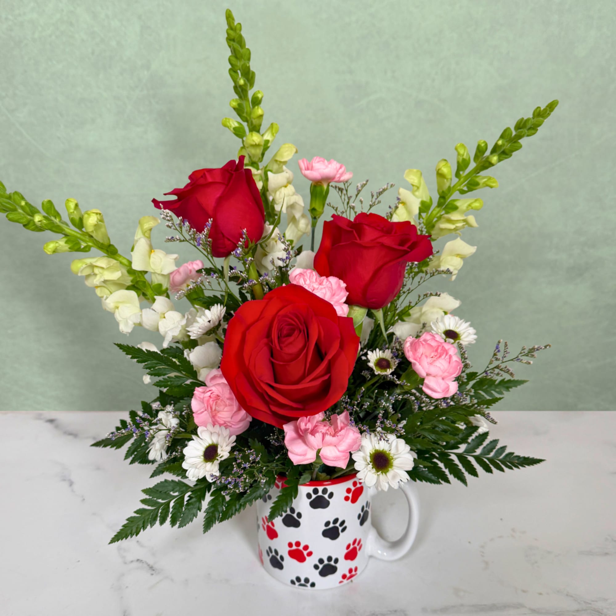 Red roses and pink carnations in a paw-print mug, photo 2 of 3