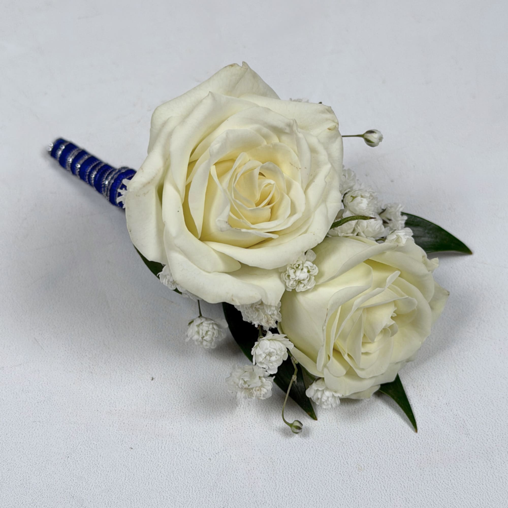 Two cream-white roses, clustered tightly with delicate white filler blooms and dark, photo 2 of 3