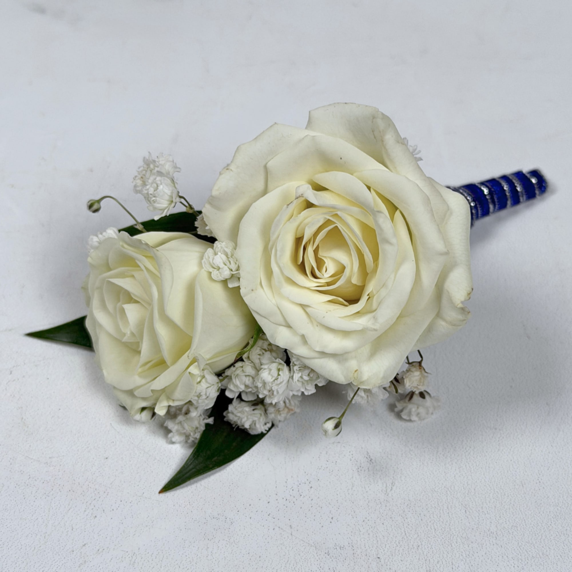 Two cream-white roses, clustered tightly with delicate white filler blooms and dark, photo 3 of 3